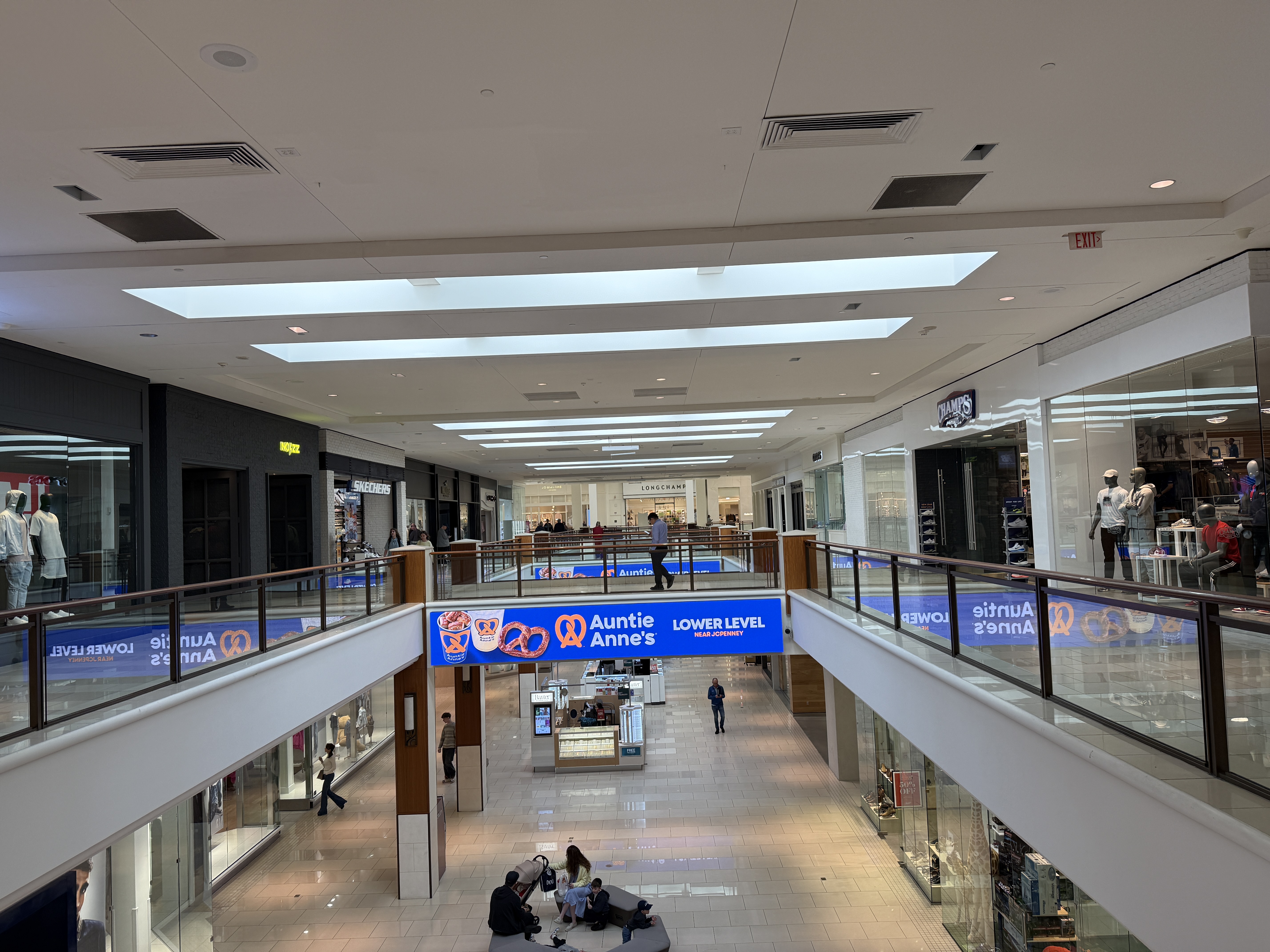 Second-floor shopping corridor at Aventura Mall with storefronts on both sides.
