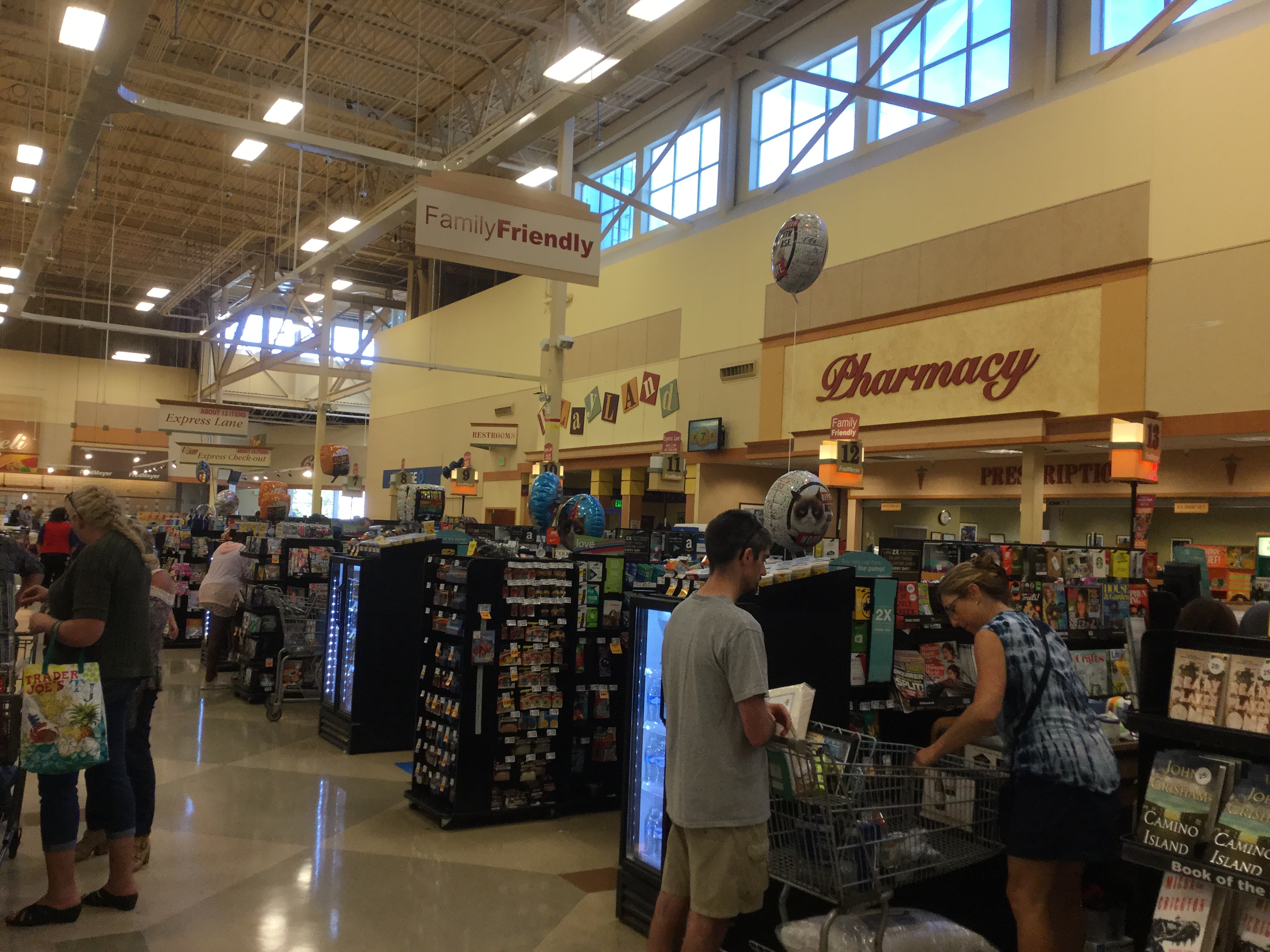 Interior of a large grocery store with checkout lanes and a pharmacy section visible.
