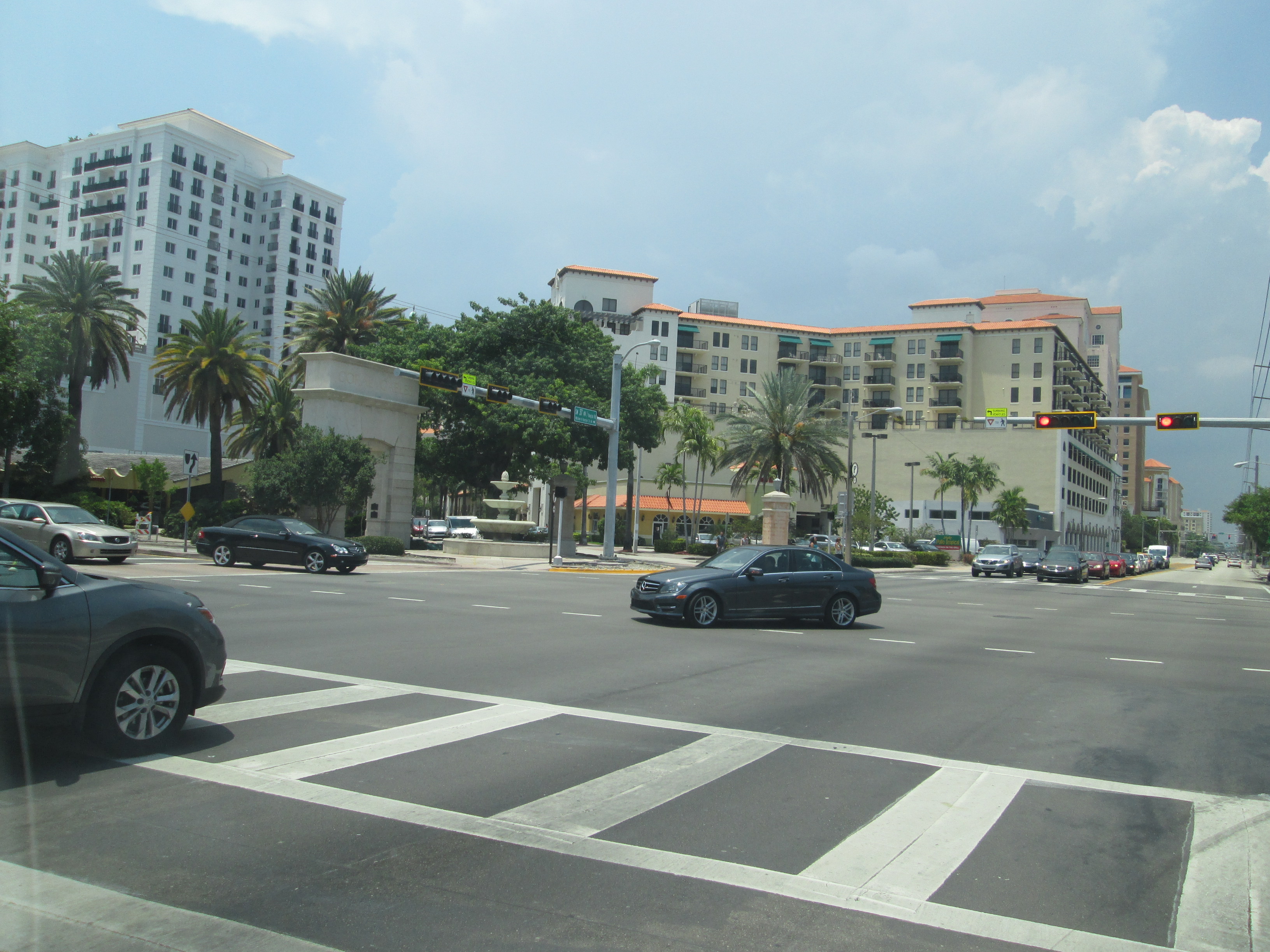 Palm-tree-lined urban intersection at the entrance to Miracle Mile.