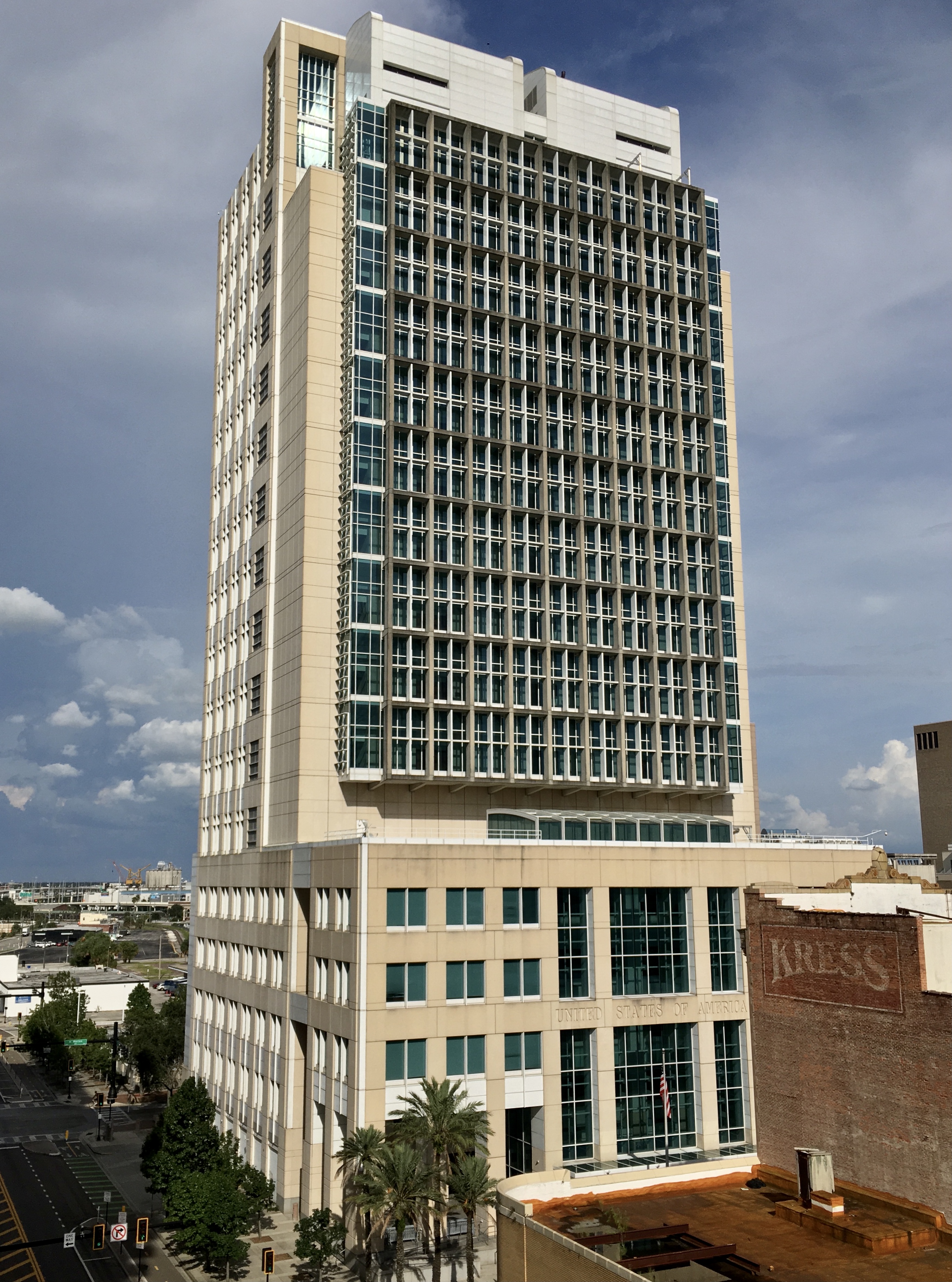 Tall glass-and-concrete federal courthouse tower in downtown Tampa.