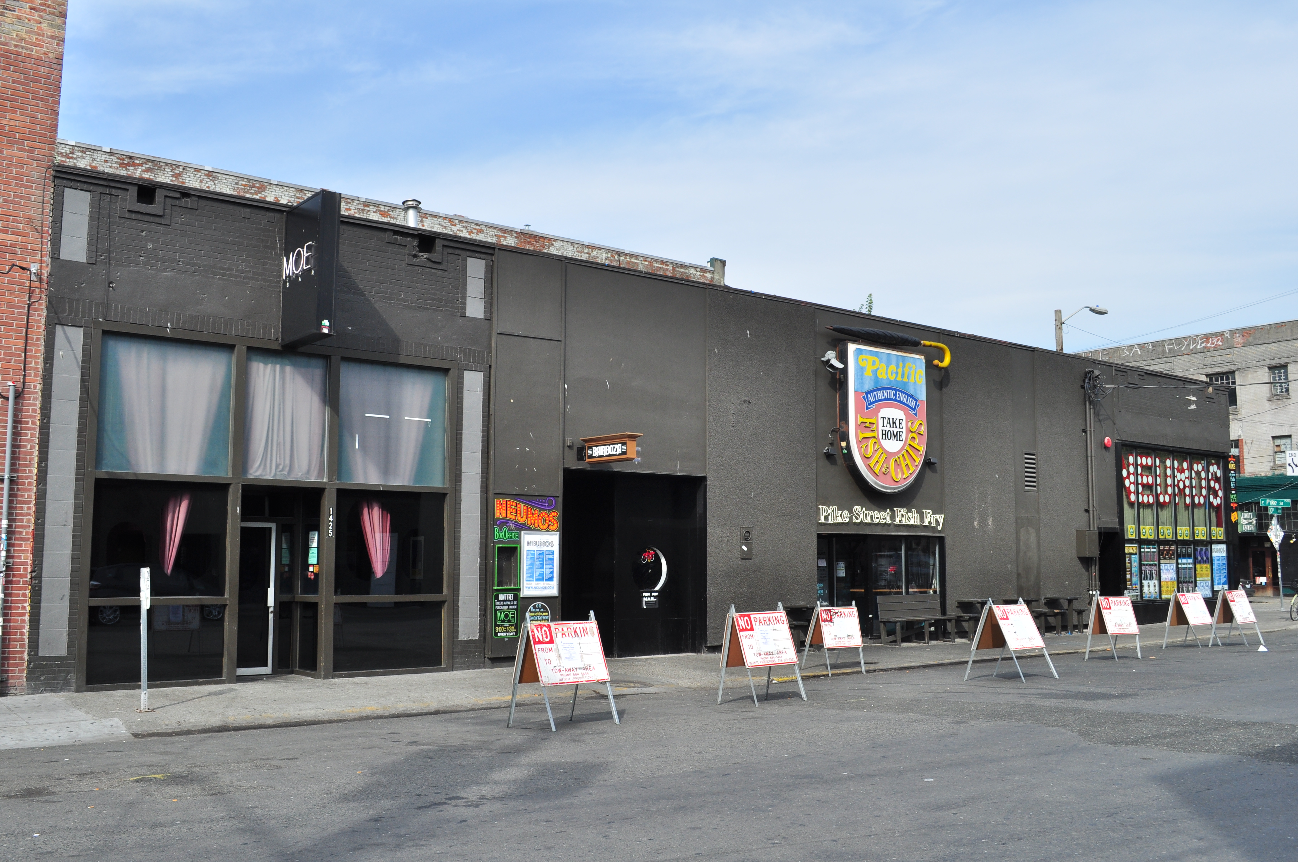 Black-painted building housing Neumos and Barboza venues on a Seattle street corner.