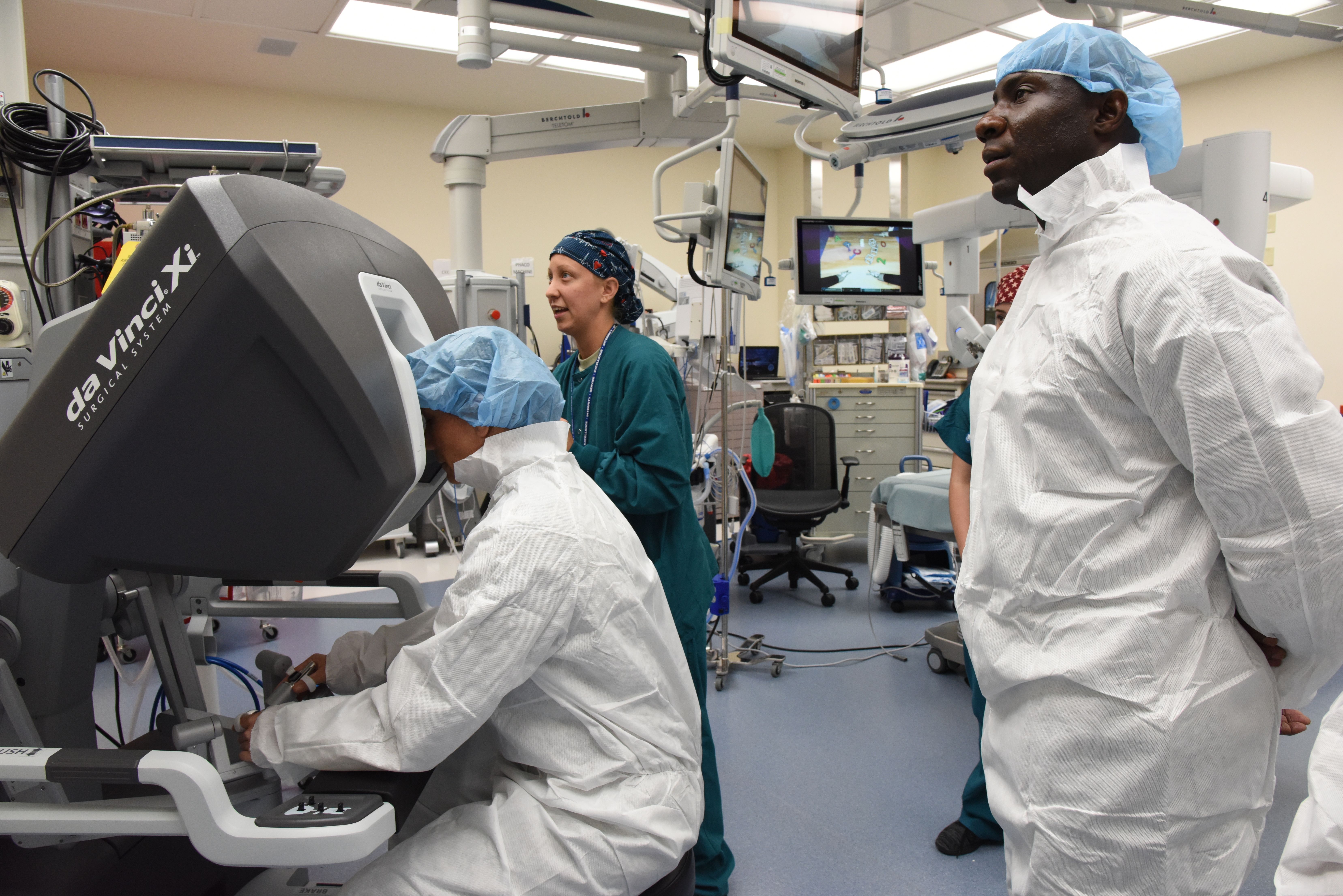 Person in surgical attire seated at a da Vinci Xi robotic surgery console.