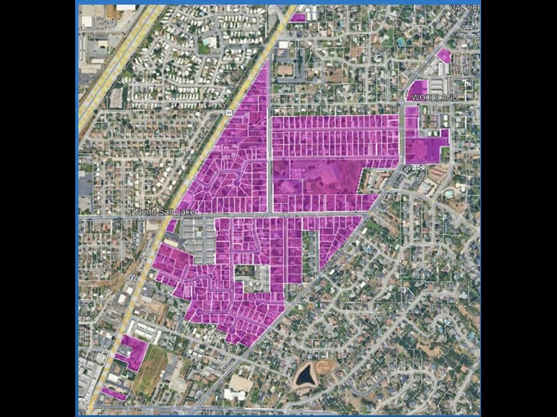 Satellite map with a magenta-highlighted residential neighborhood overlaid on a suburban street grid.