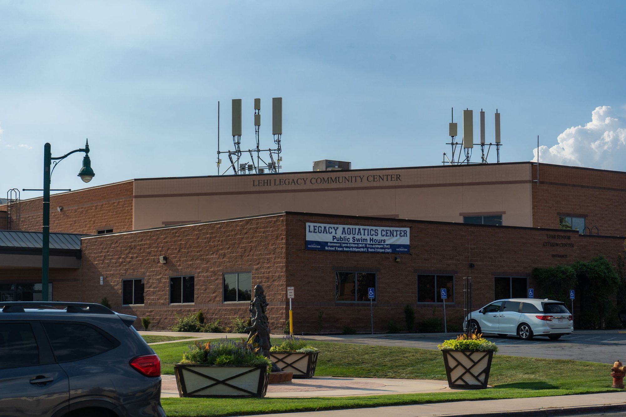 Brick community center building with aquatics center signage at the entrance.