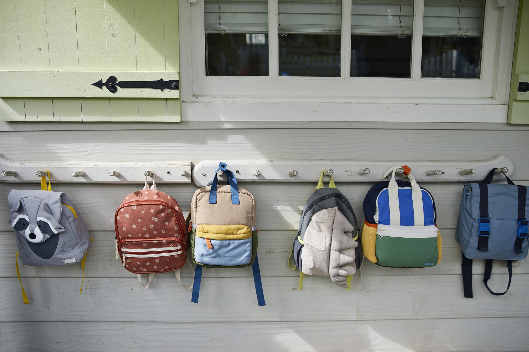 Colorful backpacks hanging side by side