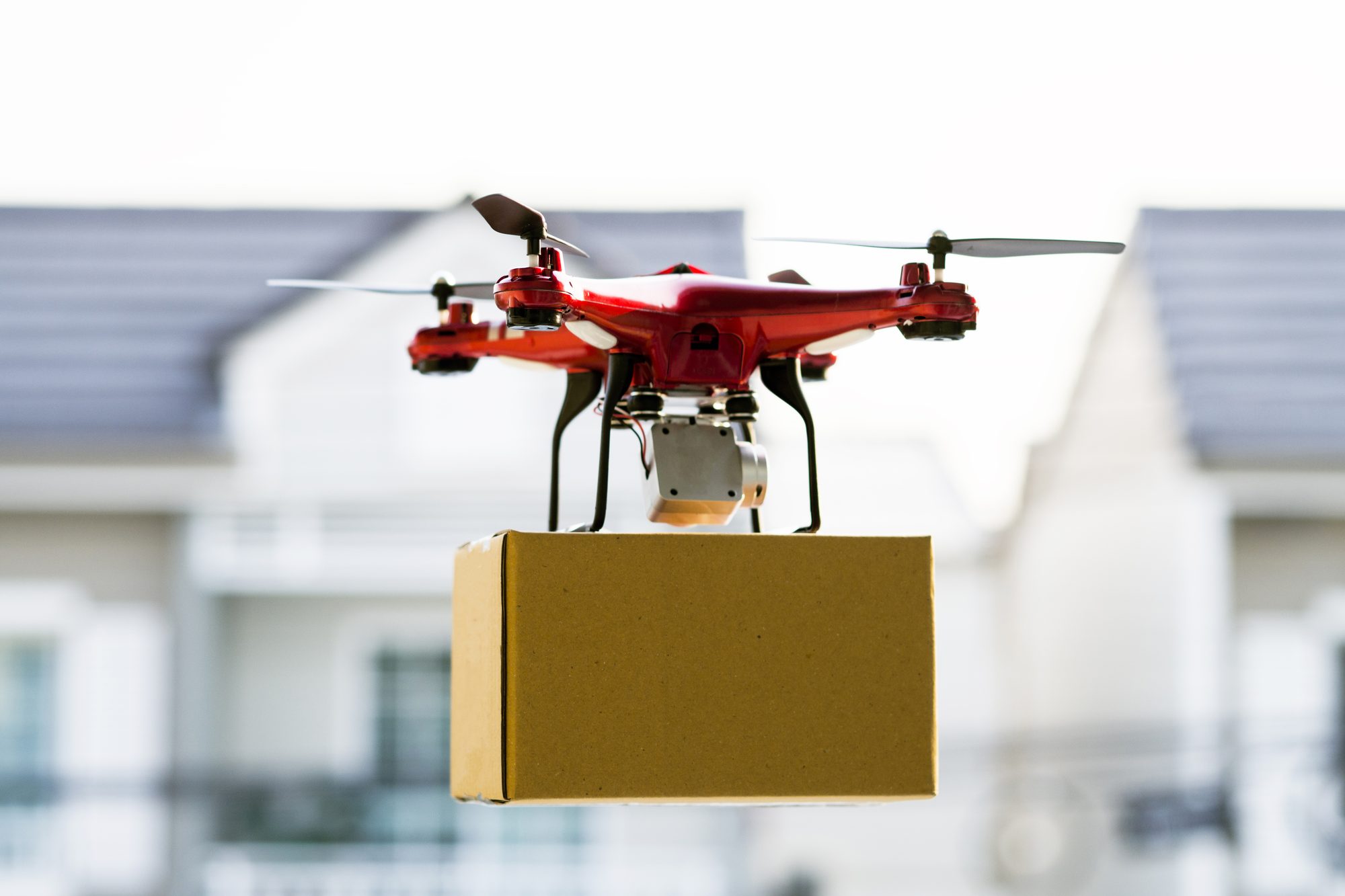 Drone delivering package over cityscape