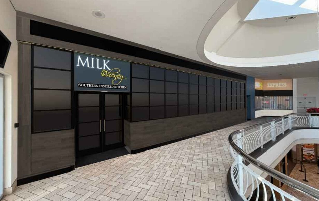 3D rendering of a restaurant storefront with dark wood paneling and glass doors in a mall setting.