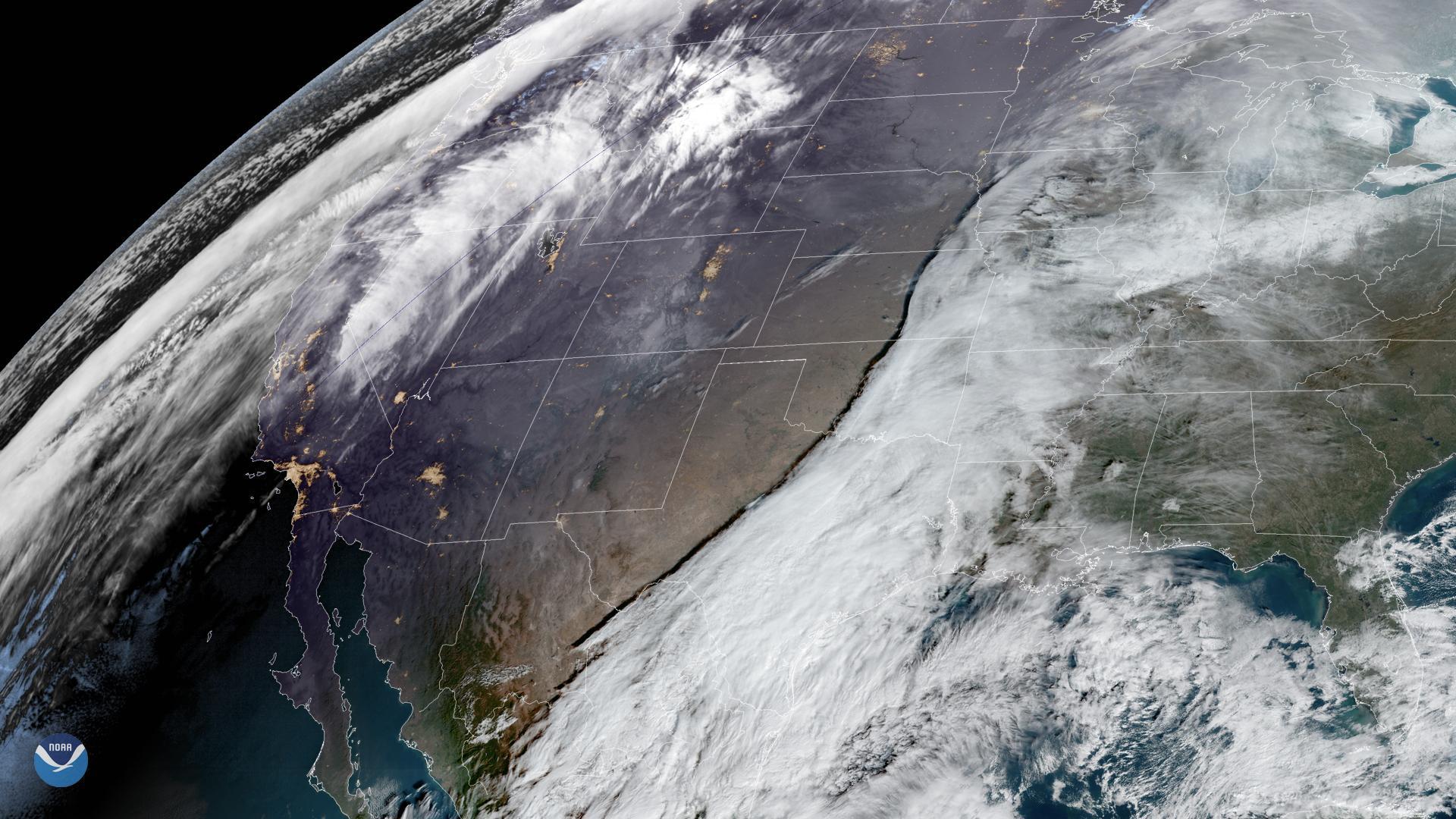 Satellite view of North America showing a large storm system and atmospheric river aimed at the Pacific Northwest coast.