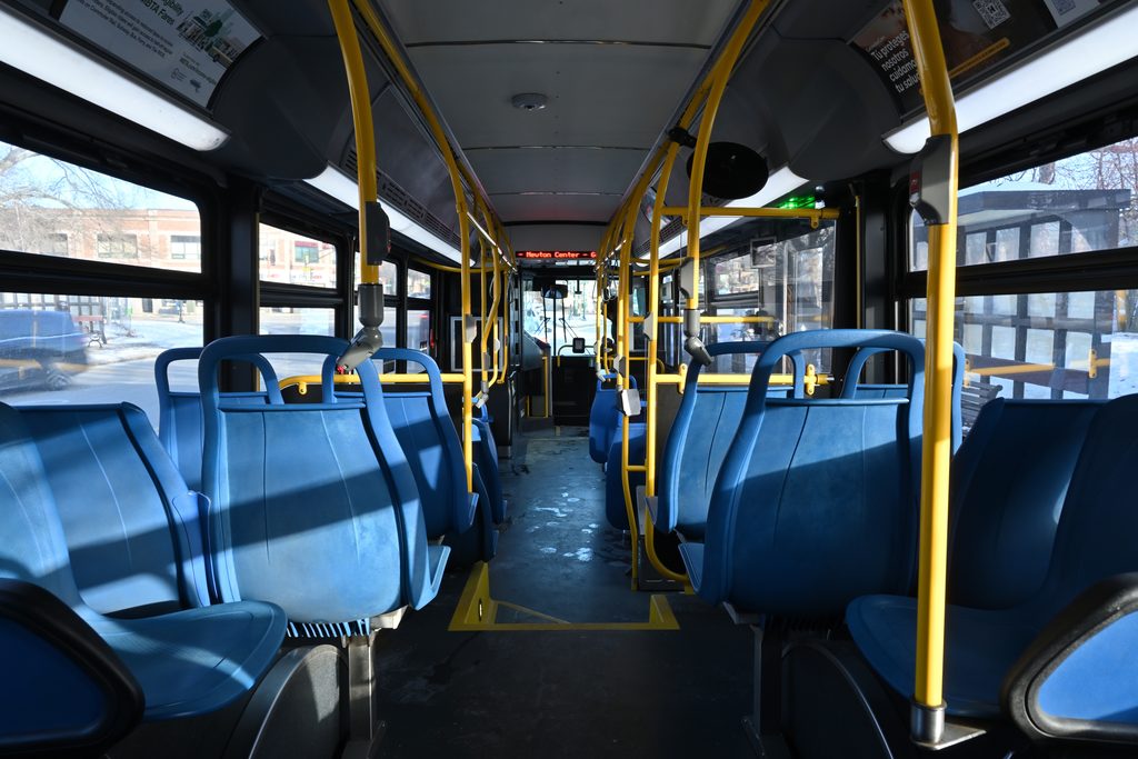 The interior of an MBTA New Flyer XN40 bus operating on route 52, stopped at the Center Street at Beacon Street stop in Newton Centre
