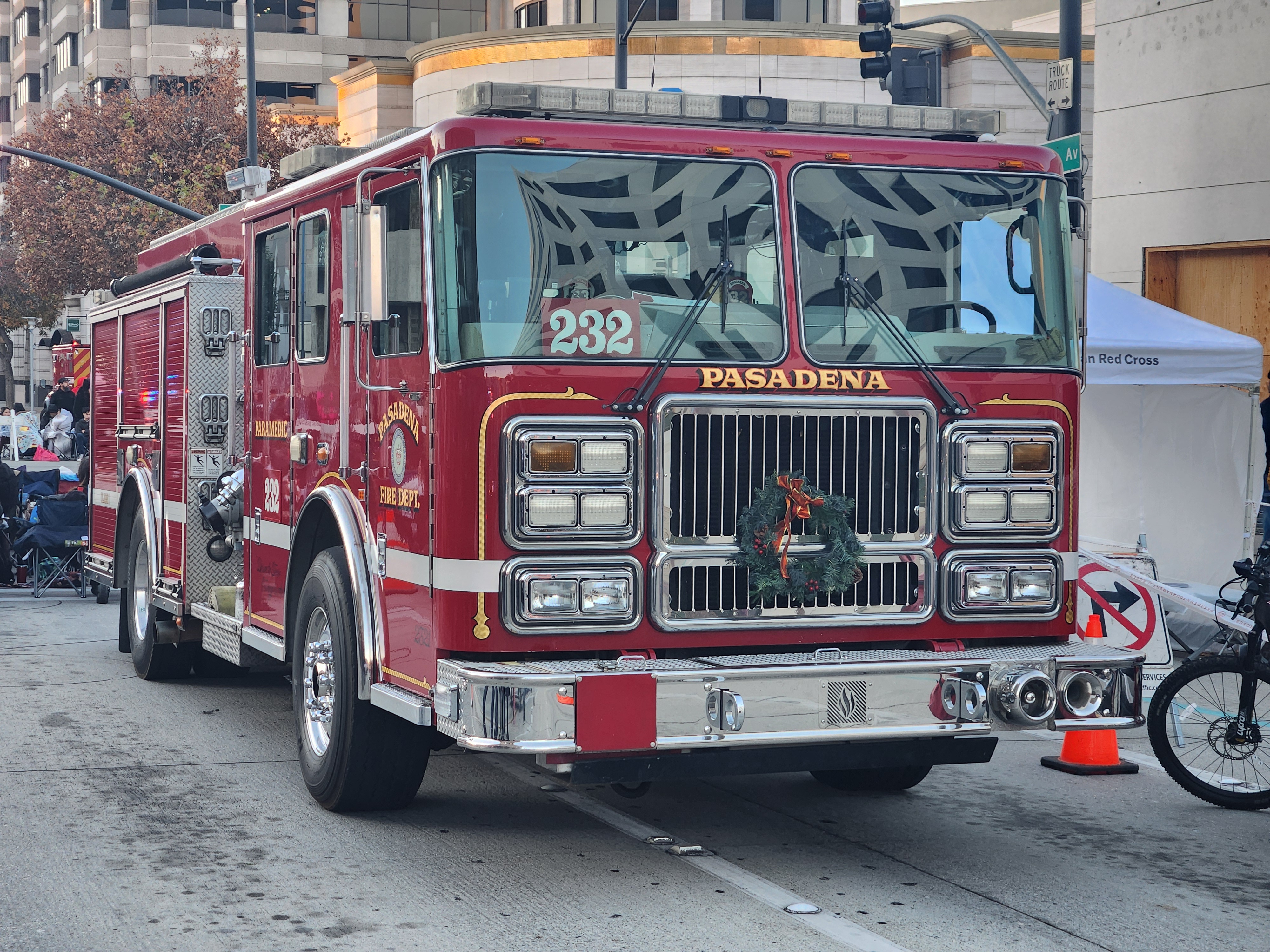 Red Pasadena Fire Department pumper truck parked on a city street.
