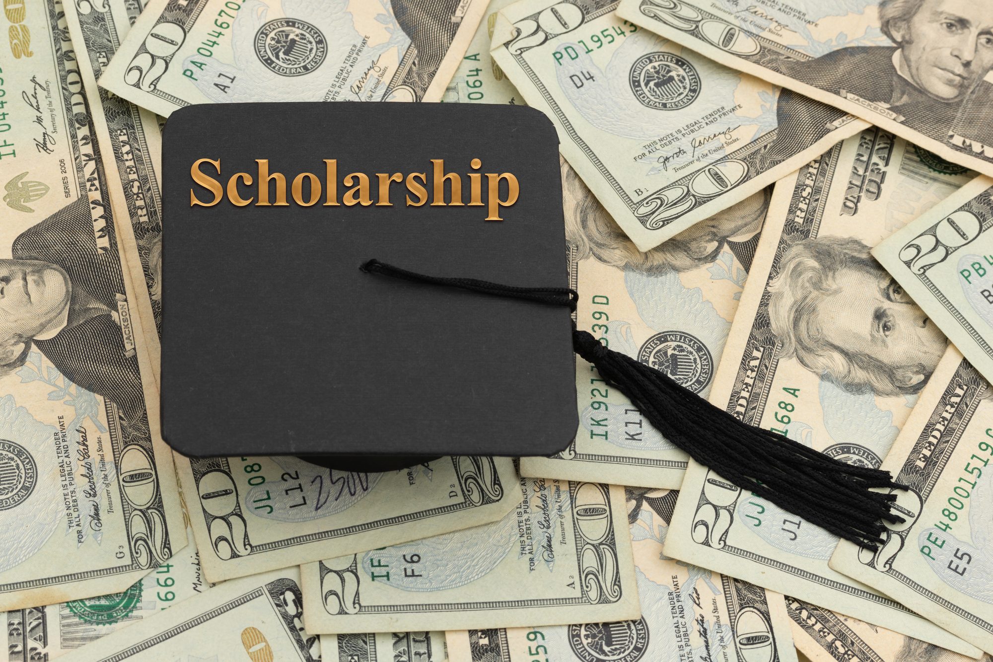Scholarship message with grad cap on money for educational costs