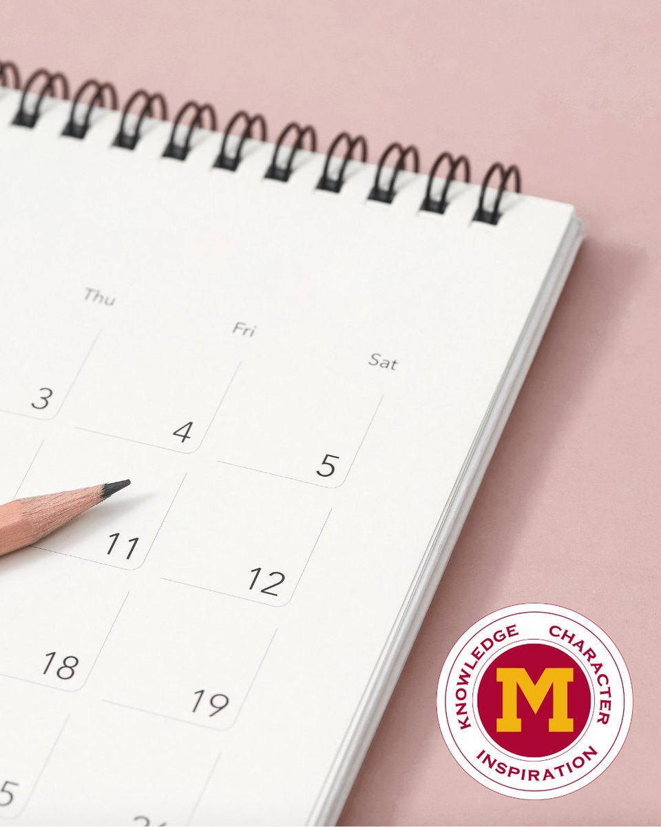 Spiral-bound calendar open to a month, with a pencil resting on it and a school district seal in the corner.