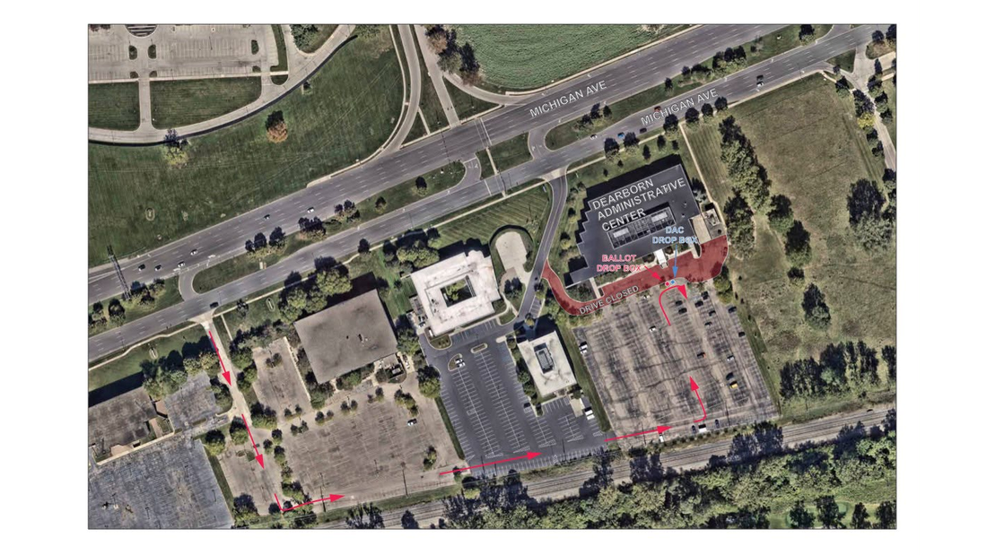 Aerial satellite view of a large municipal building with parking lots and a labeled ballot drop box.