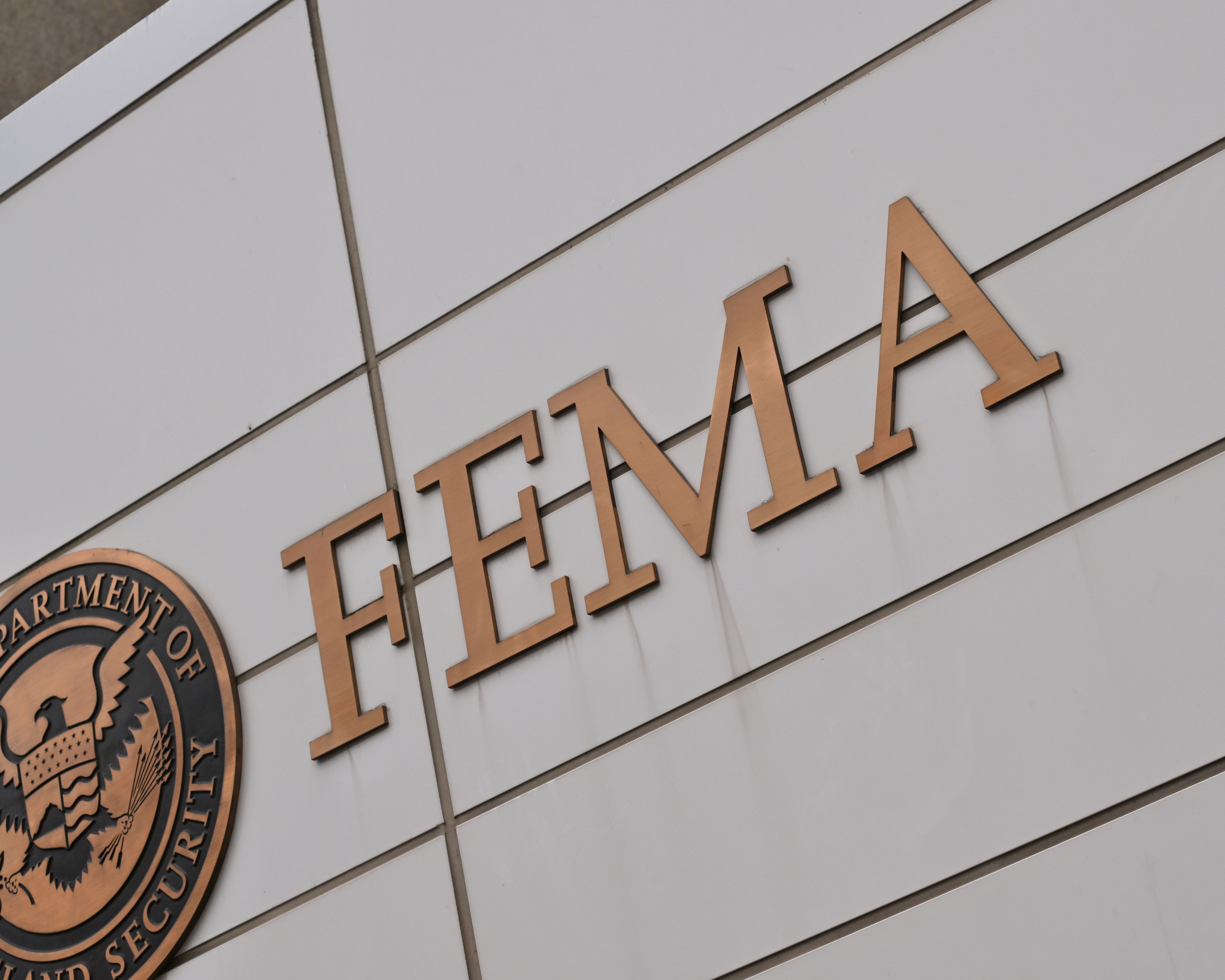 Bronze FEMA sign on the exterior wall of the agency's Washington headquarters building.