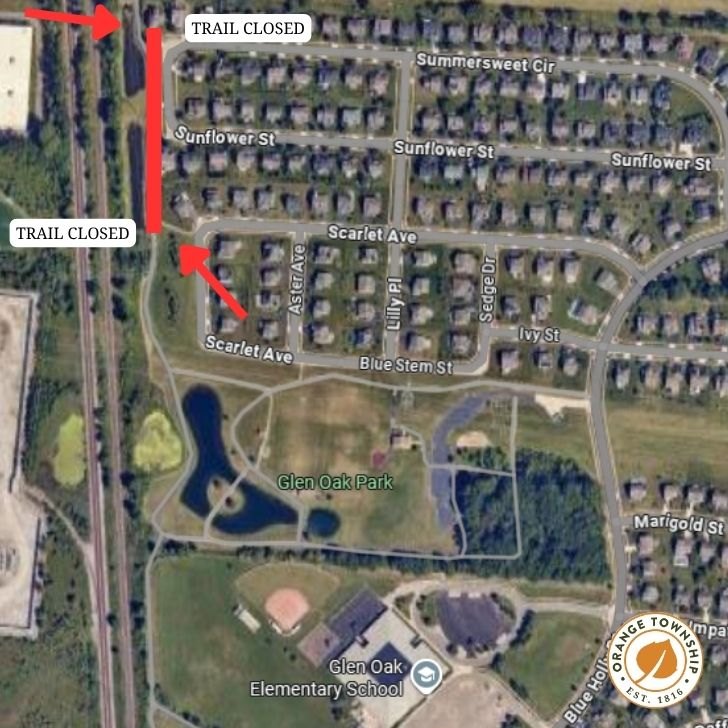 Satellite map showing two trail-closed markers along a residential trail near a park and elementary school.