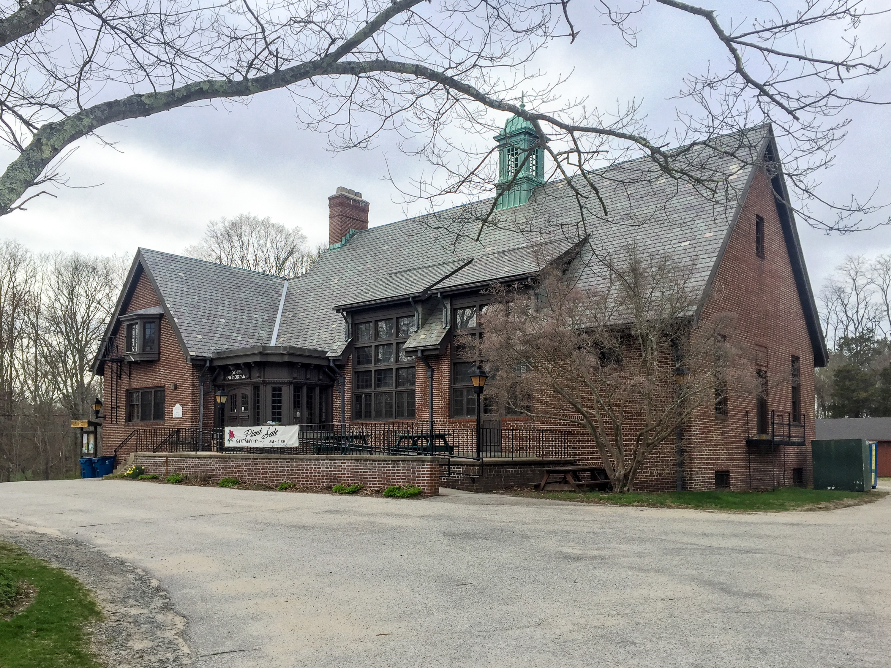 Brick public library building with a copper cupola and large windows.
