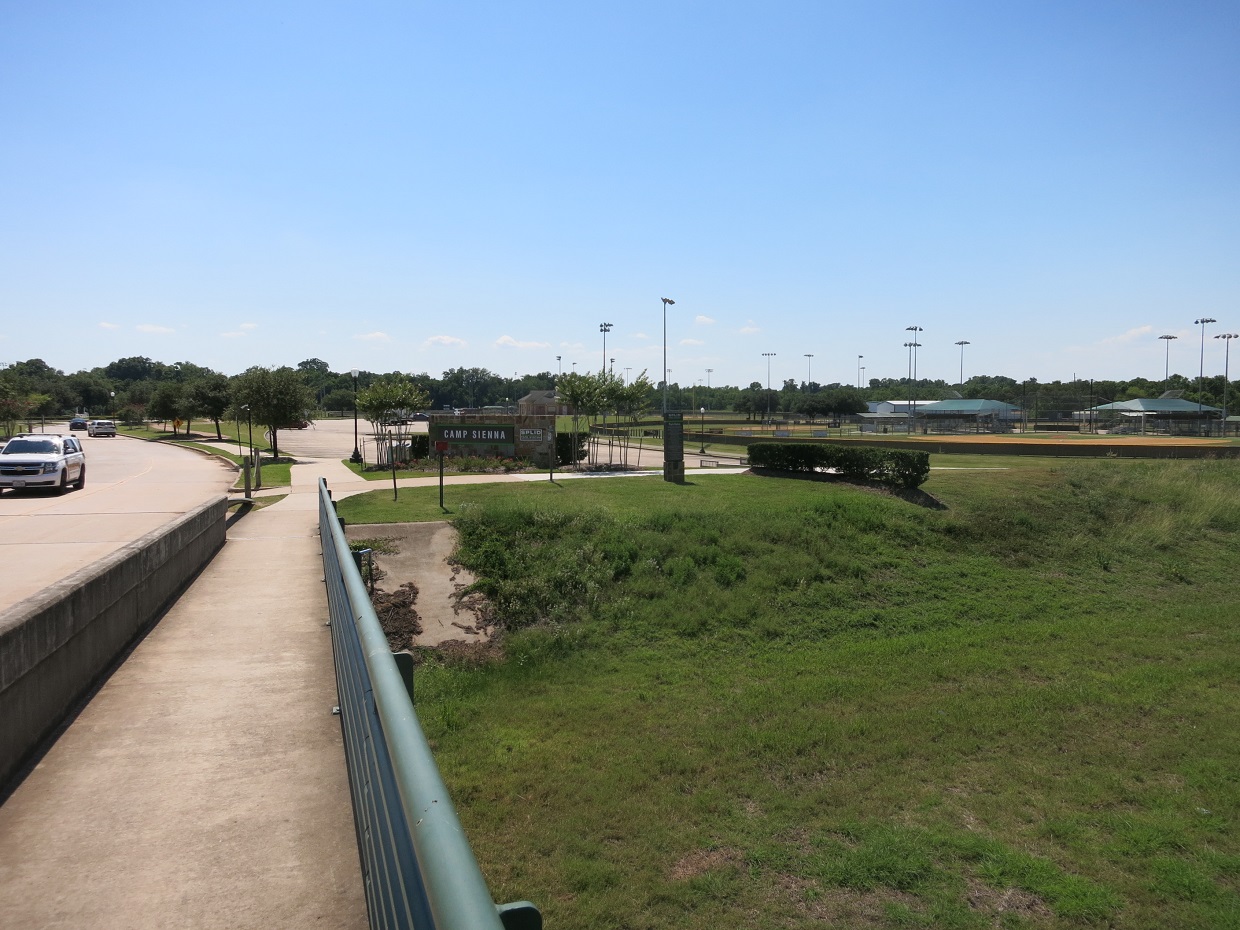 Park entrance sign and baseball fields at Camp Sienna in Missouri City, Texas.