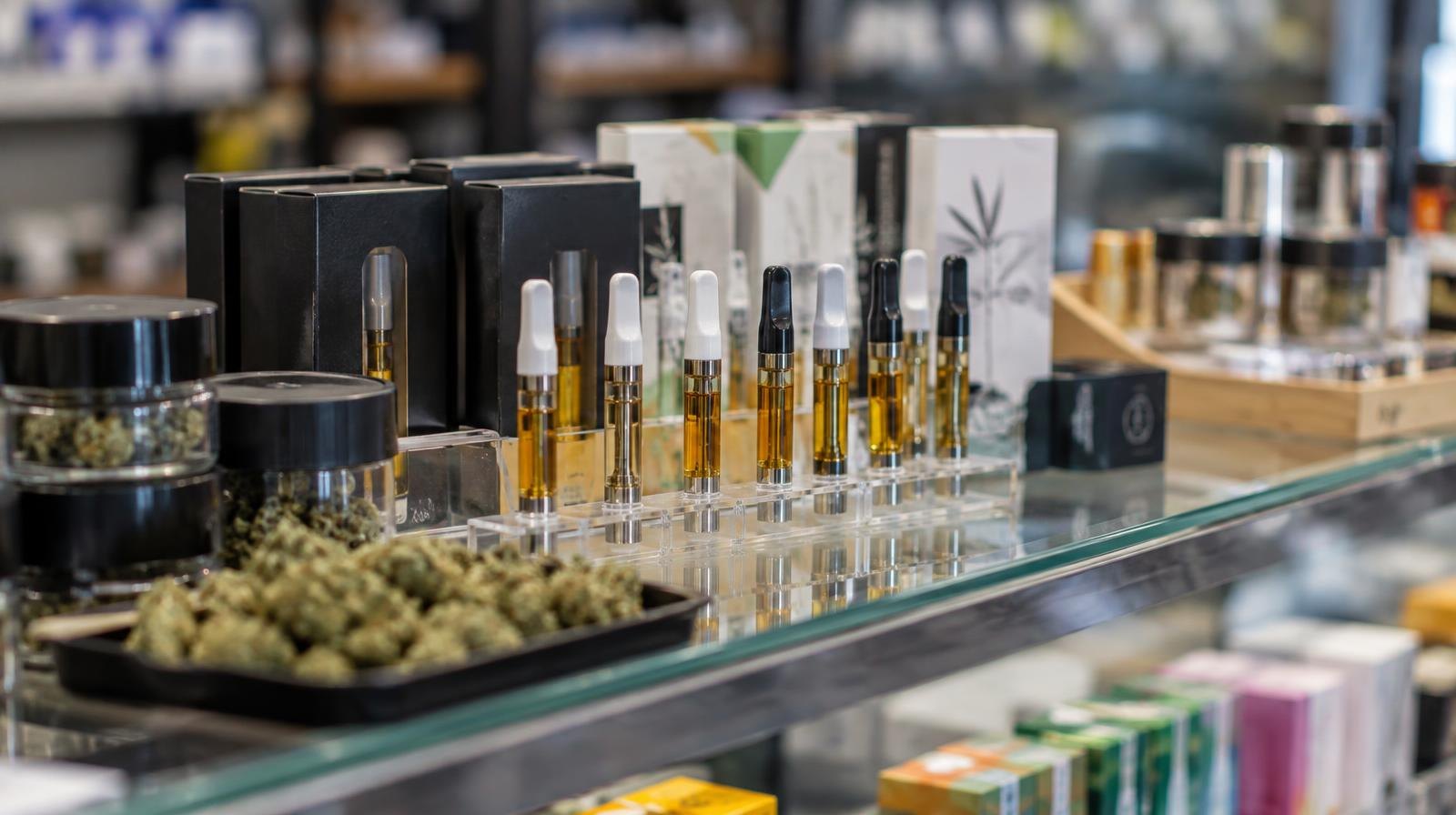 Glass display case filled with vape cartridges and cannabis products.