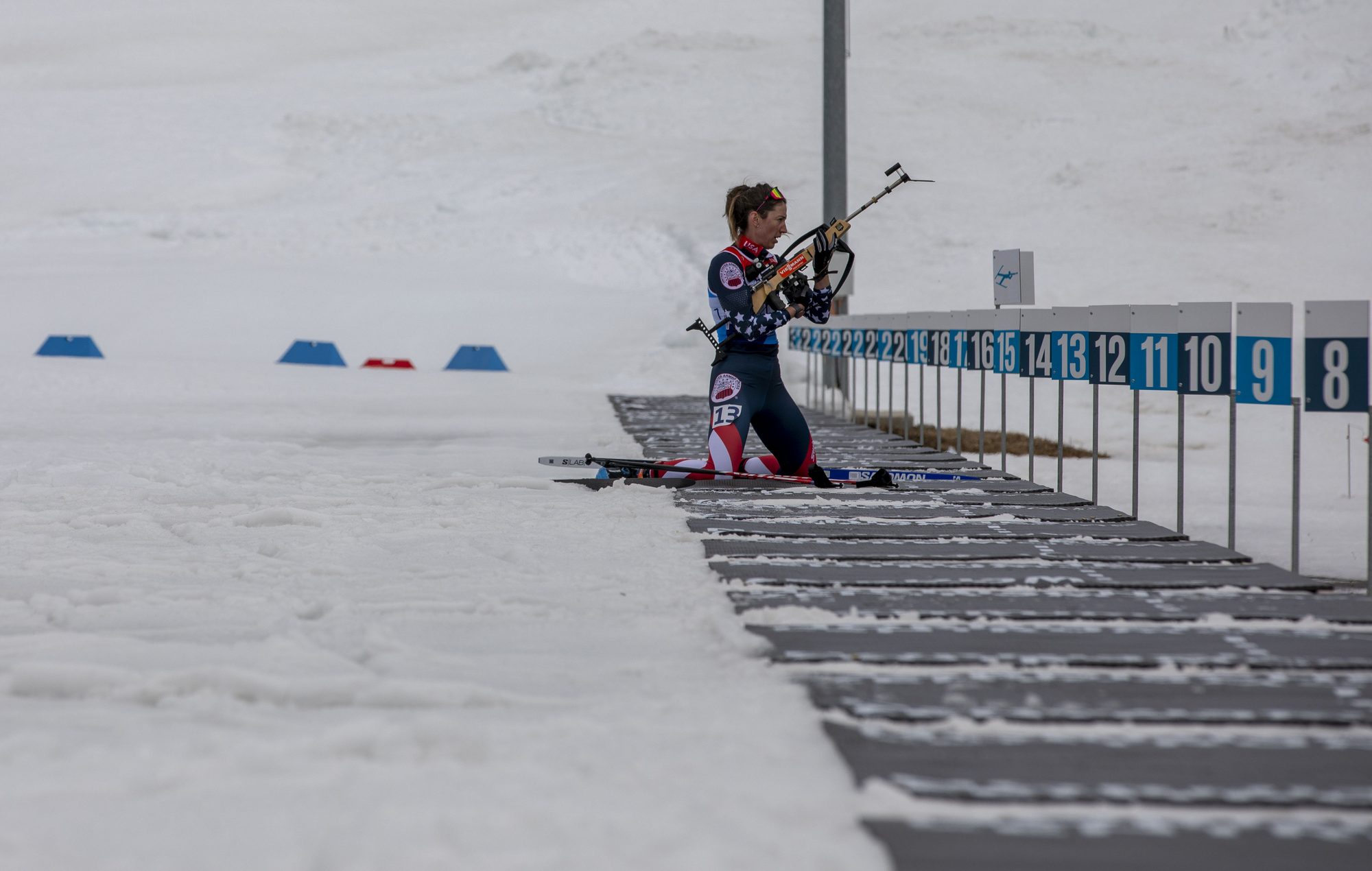 U.S. Army Sgt. Deedra Irwin, 86th Troop Command, Vermont National Guard, prepares her rifle as she enters the shoot of a biathlon race at the Goms Nordic Center, in Geschinen, Switzerland, on Mar. 25, 2025. Sgt.