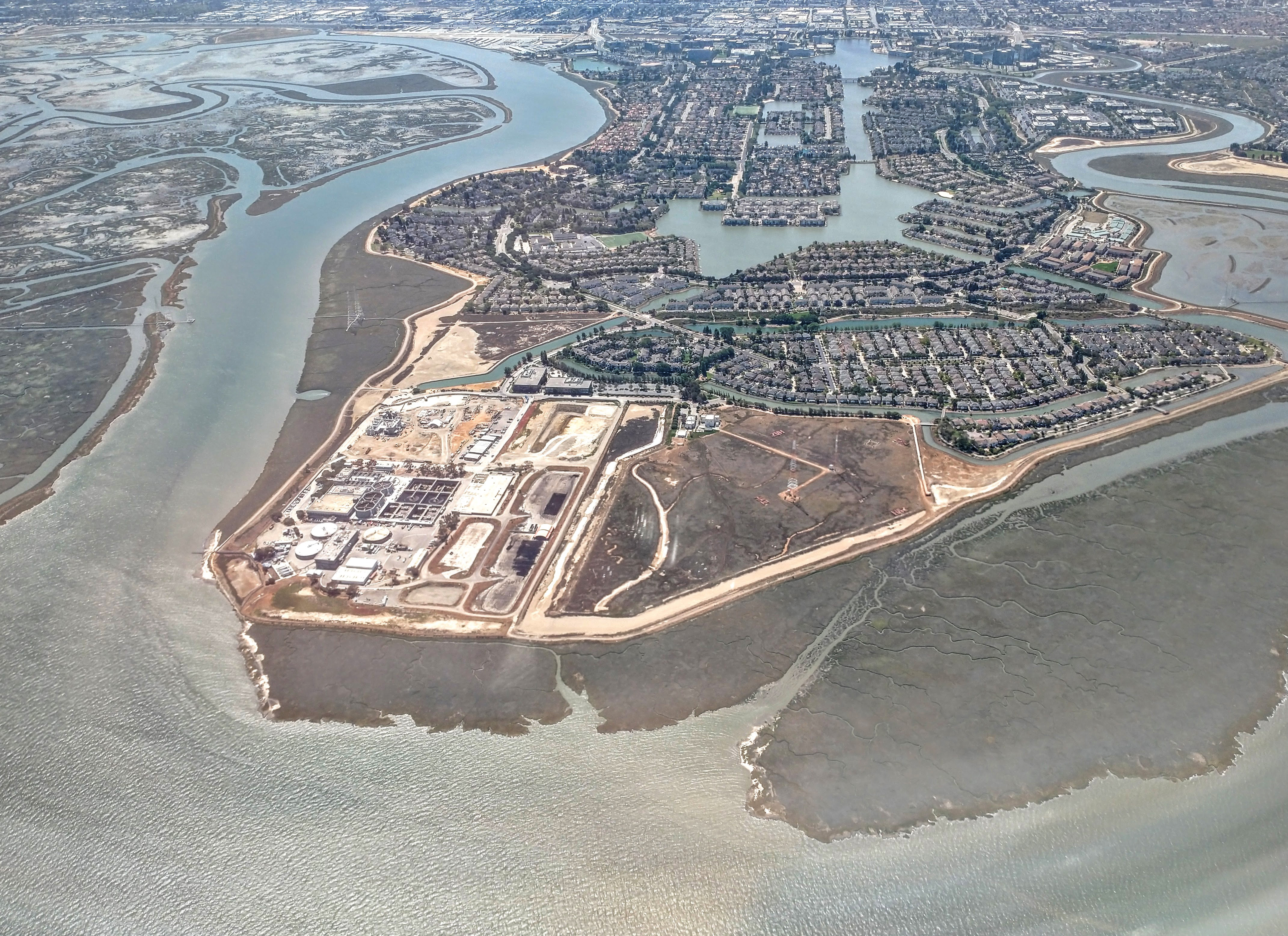 Aerial view of a Bay Area peninsula flanked by tidal sloughs and Bay mudflats.