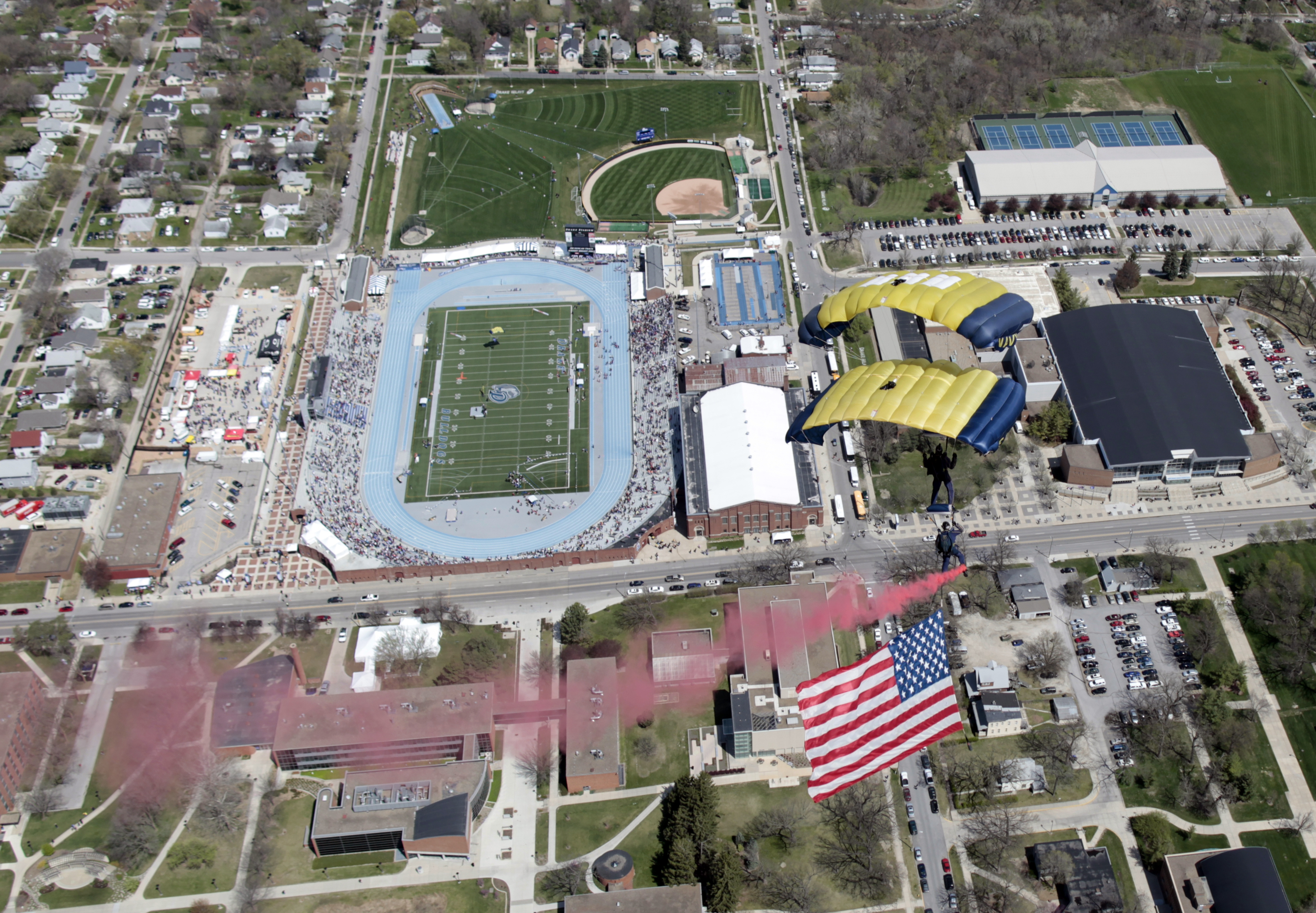 Aerial view of a stadium with a blue running track surrounded by stands.