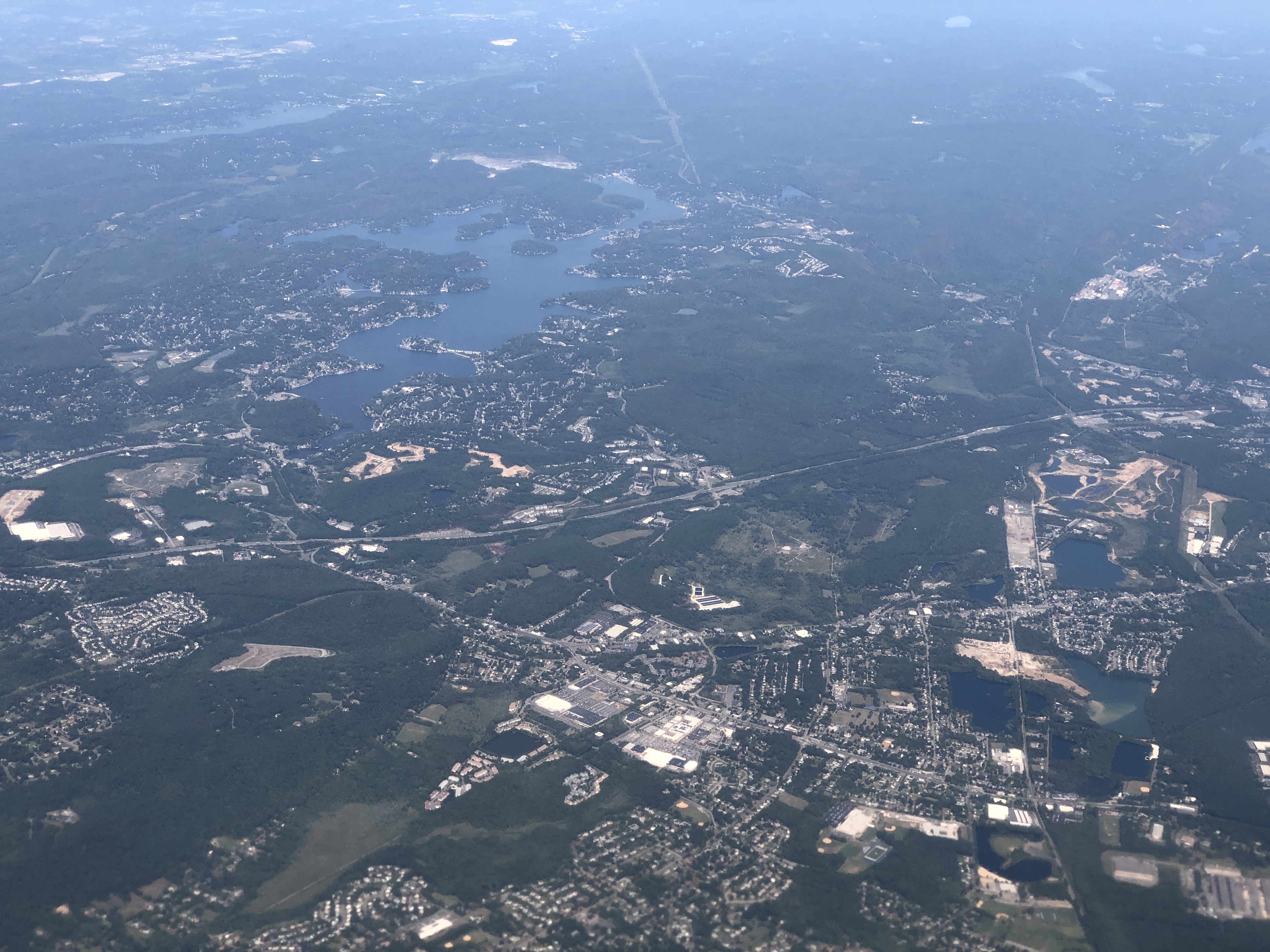 Aerial view of suburban and rural areas in Roxbury Township, Morris County, New Jersey with a lake visible.