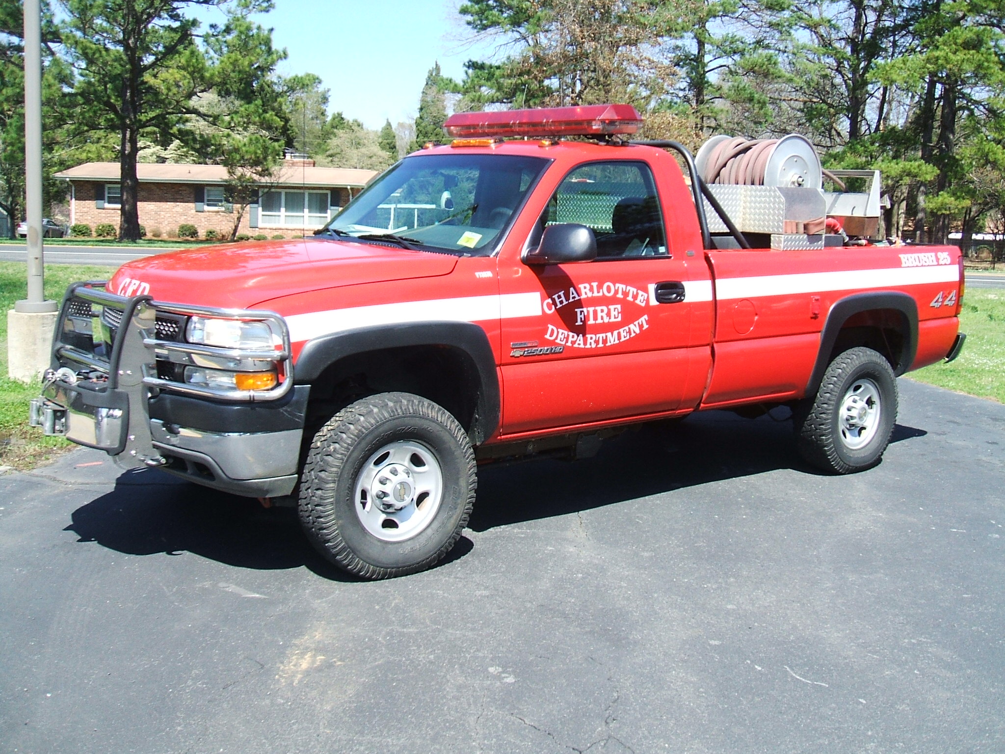 Red Charlotte Fire Department pickup truck with emergency light bar on roof.