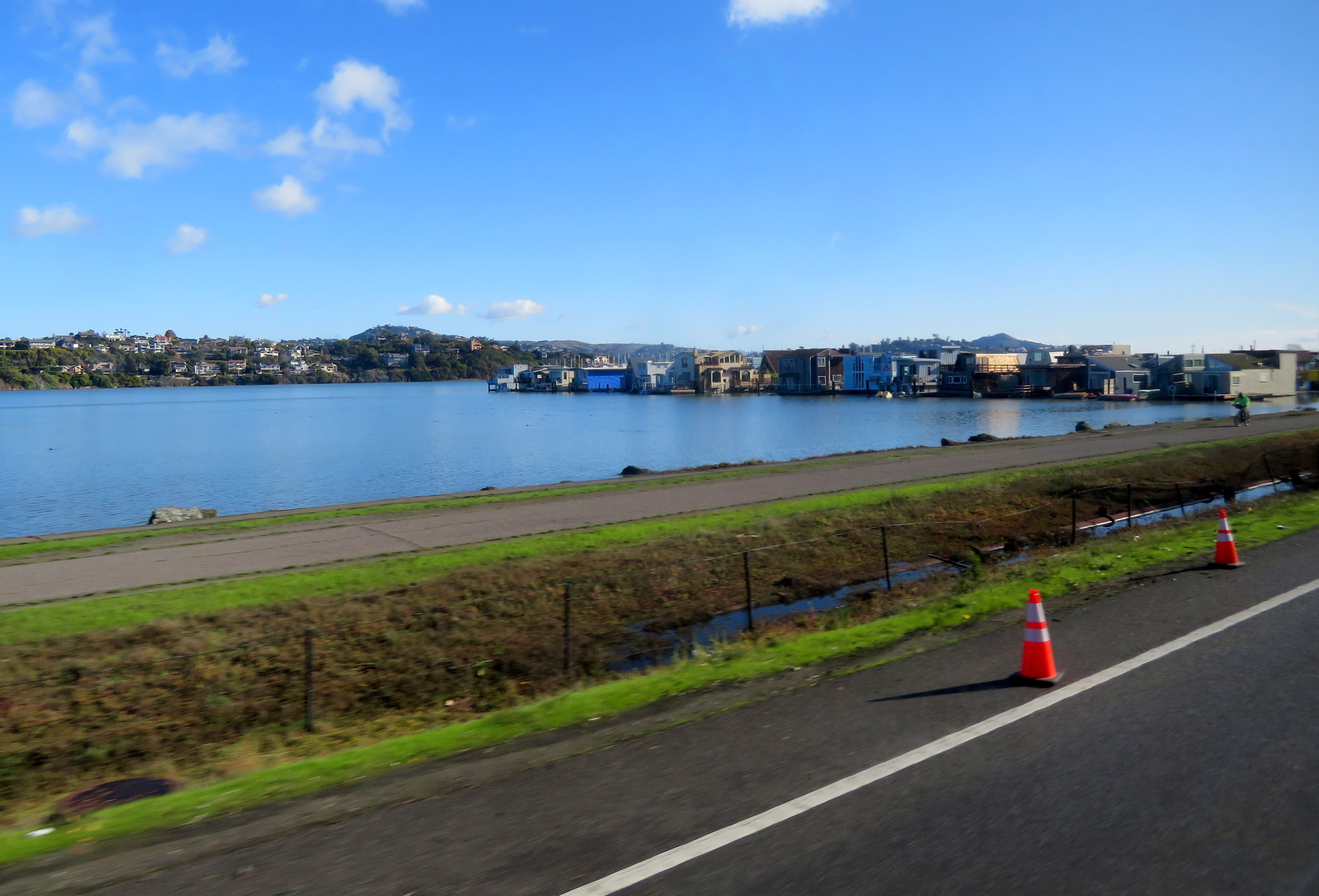 View of a calm bay with colorful waterfront buildings along the far shore.