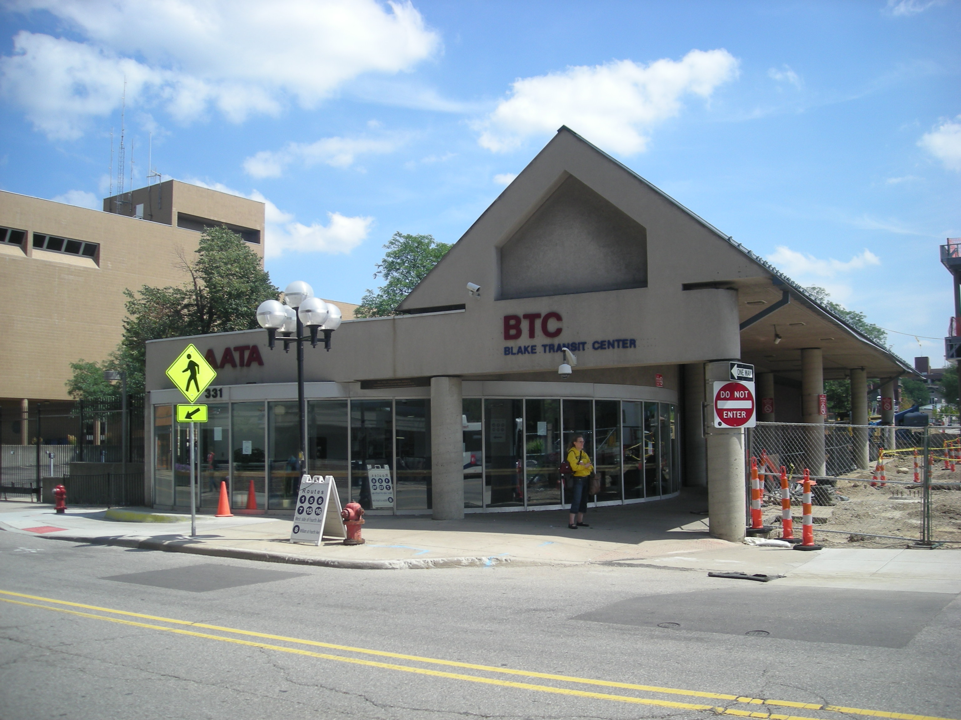 The Blake Transit Center building with orange construction fencing visible in an adjacent lot.