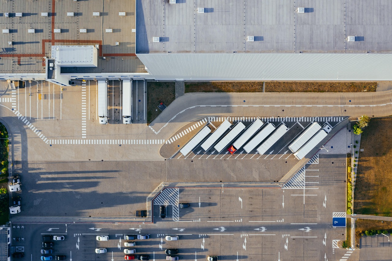 Production, facility, logistic, distribution center, transit, truck, transport, top view, industrial, semi, aerial view,