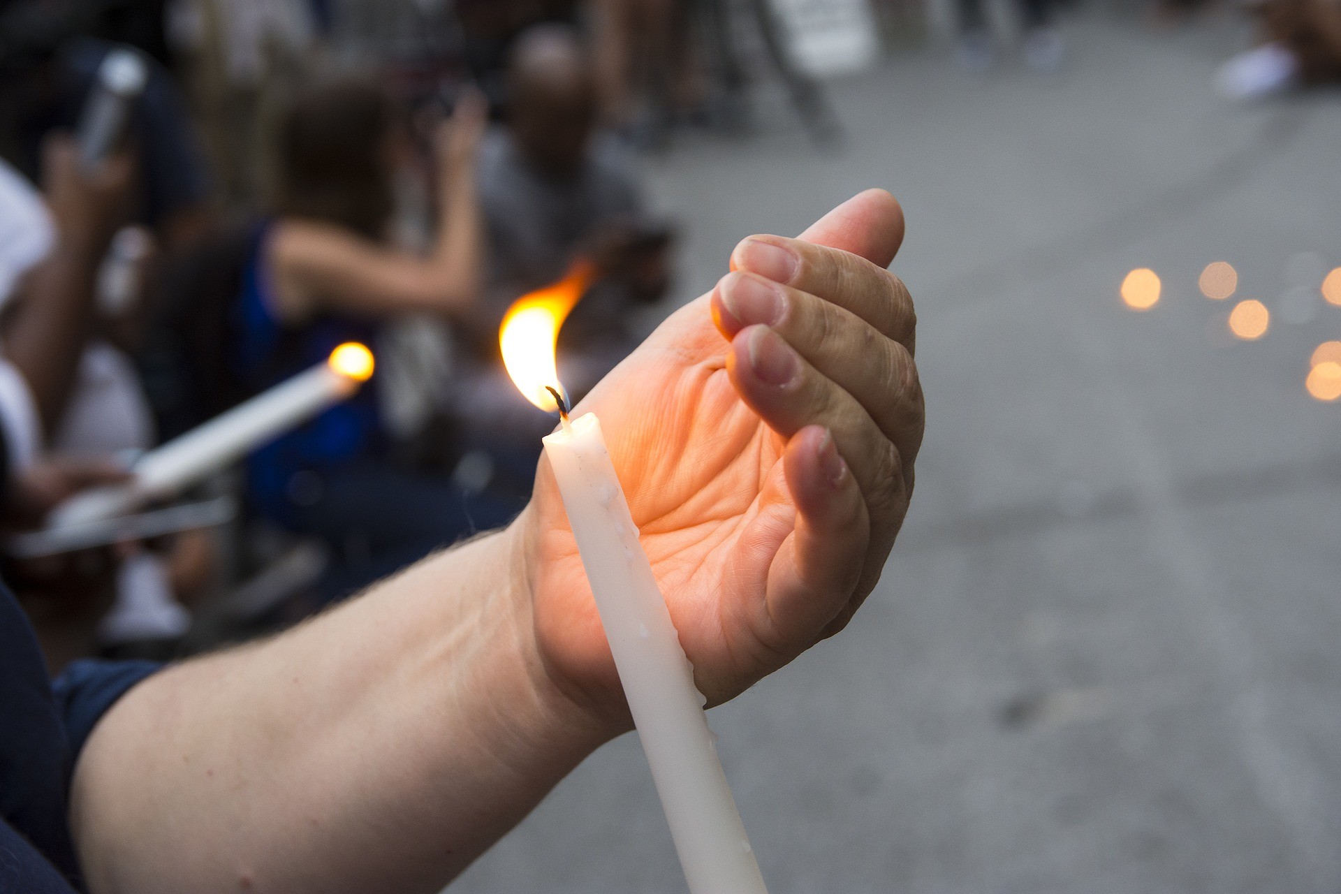A candle at a vigil being lit