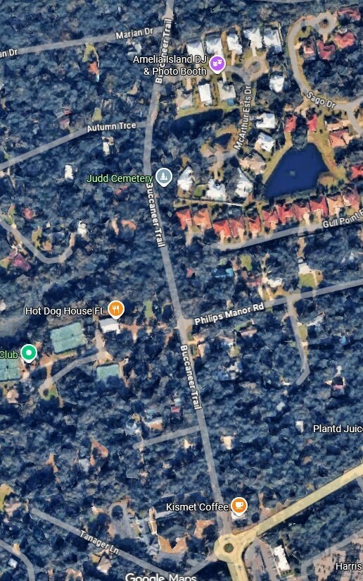 Aerial map showing Buccaneer Trail running north-south through a wooded residential area.