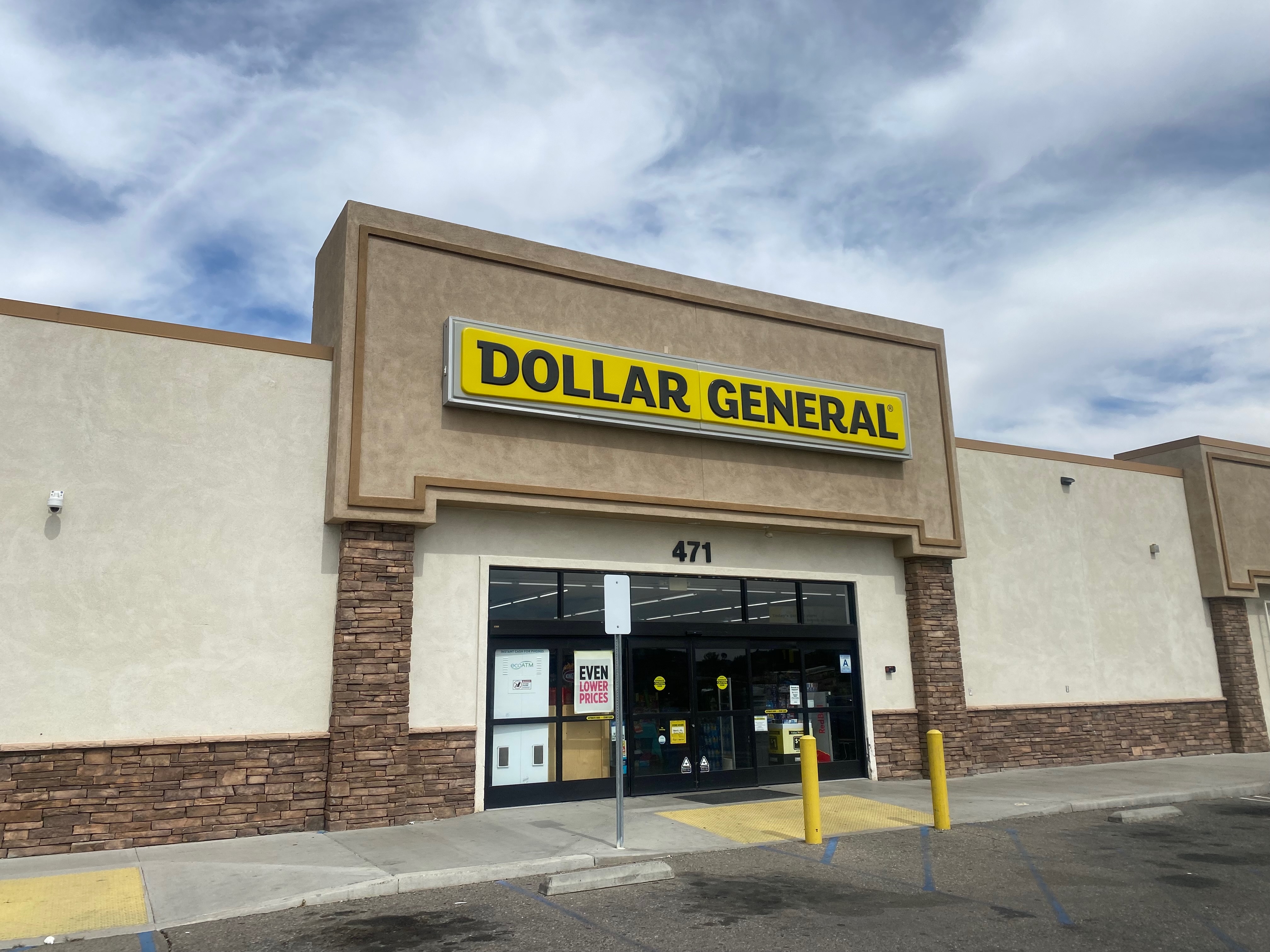 Exterior of a Dollar General store with yellow sign above the entrance.