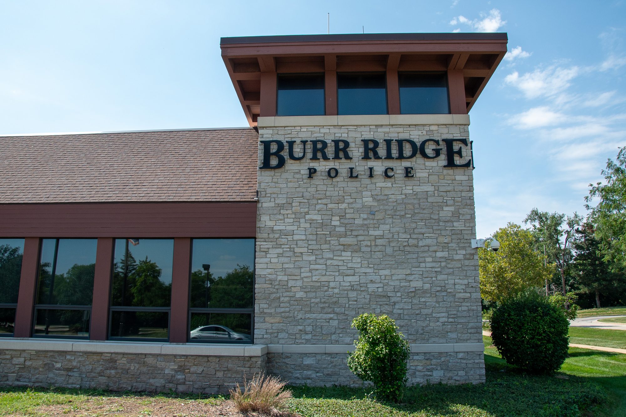 Exterior stone facade of a police station building with signage visible
