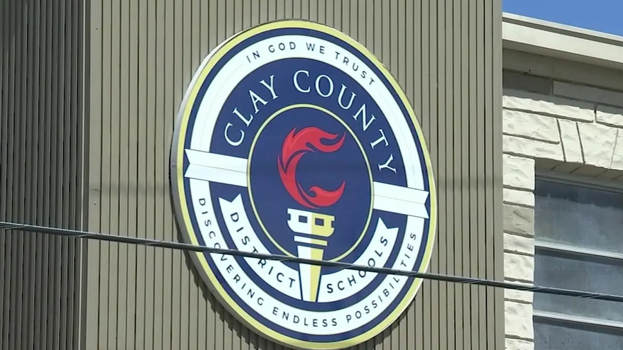 Circular Clay County District Schools seal mounted on a building exterior.