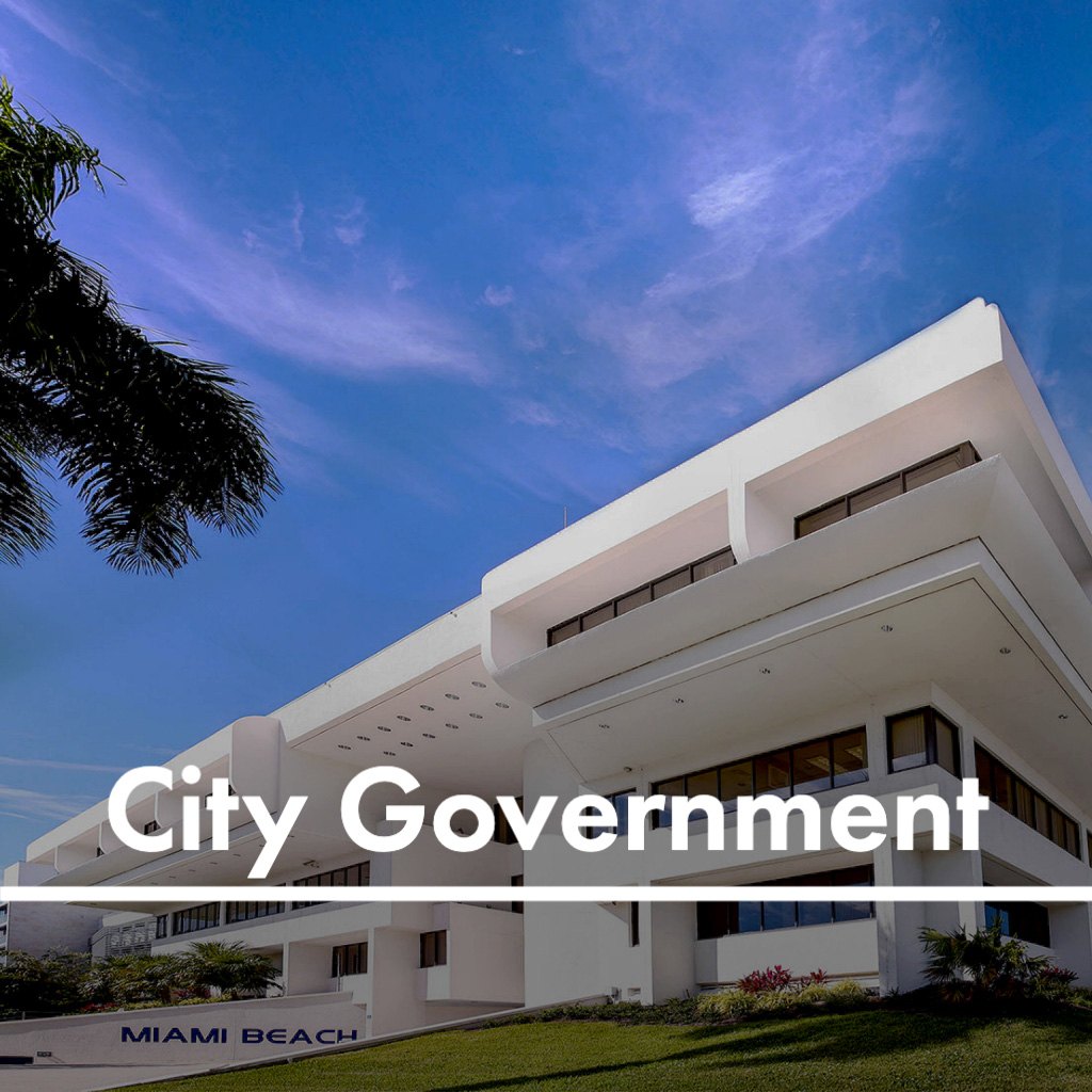 White modernist Miami Beach City Hall building with palm tree and blue sky.