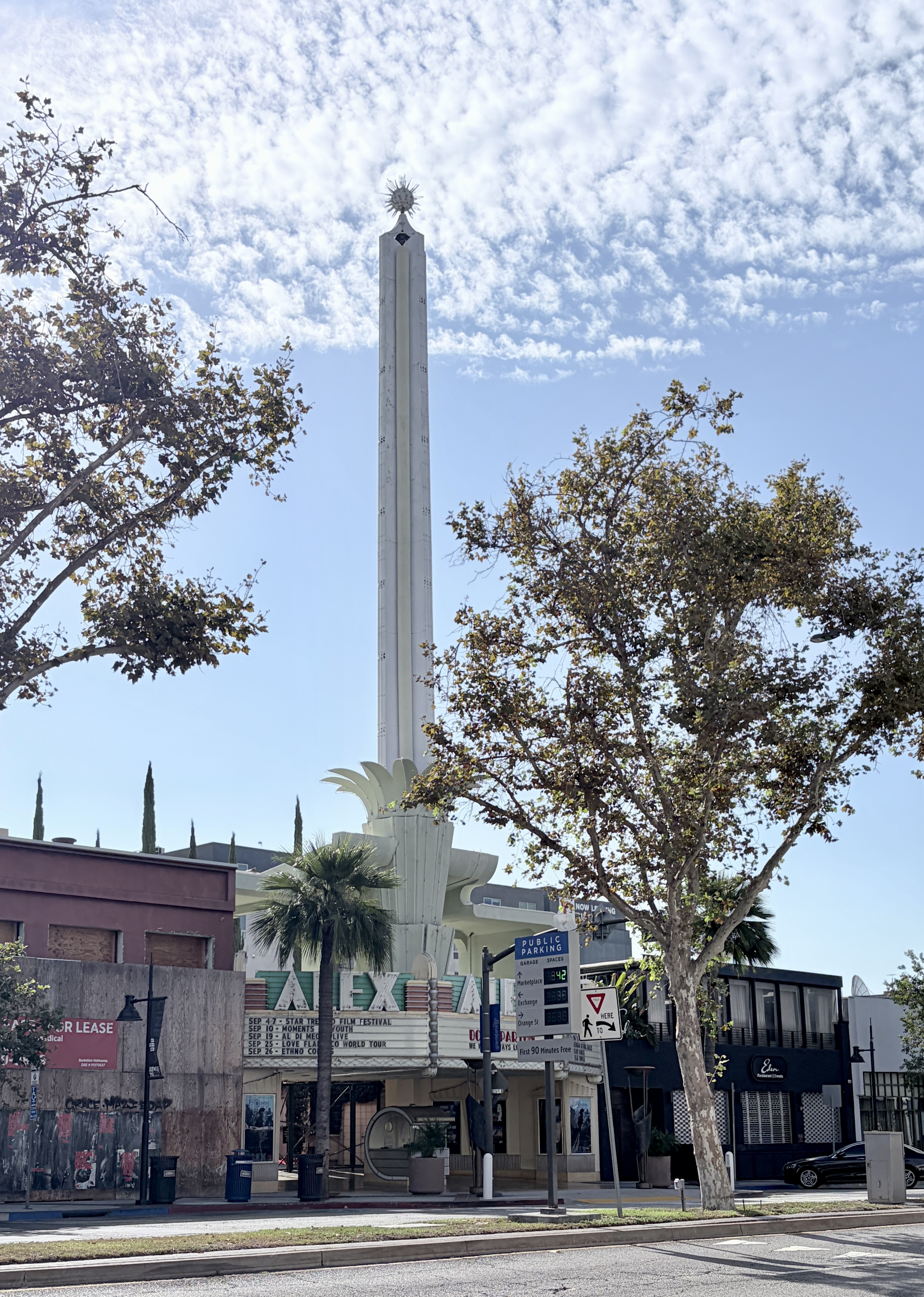 Exterior of the Alex Theatre showing its Art Deco obelisk tower and marquee sign.