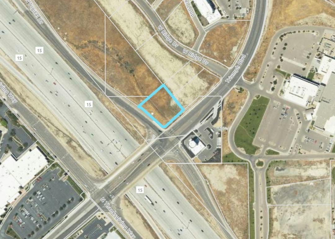 Aerial satellite view of a highlighted parcel near an Interstate 15 interchange.