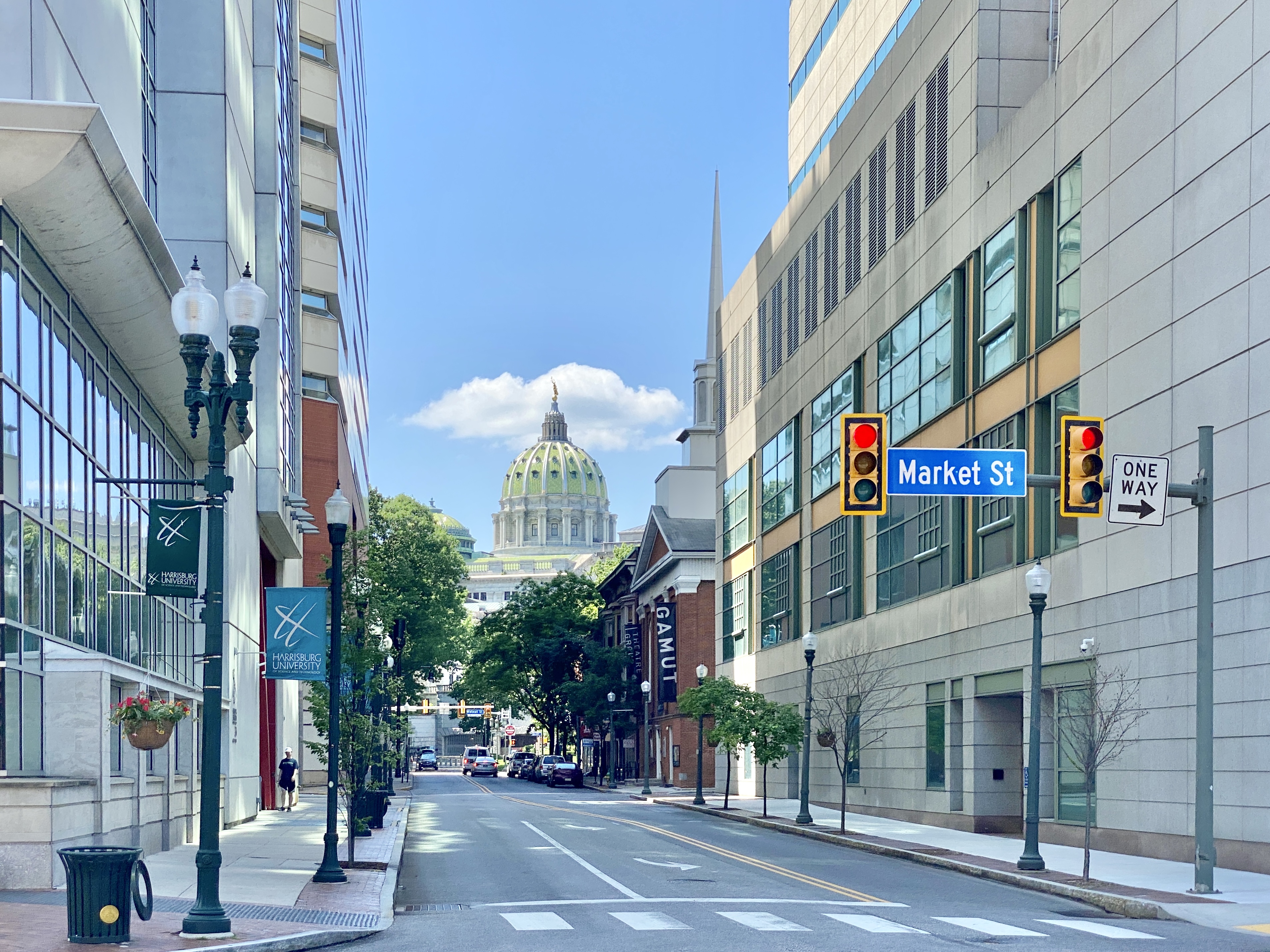 Street-level view toward the Pennsylvania State Capitol's green dome in Harrisburg.