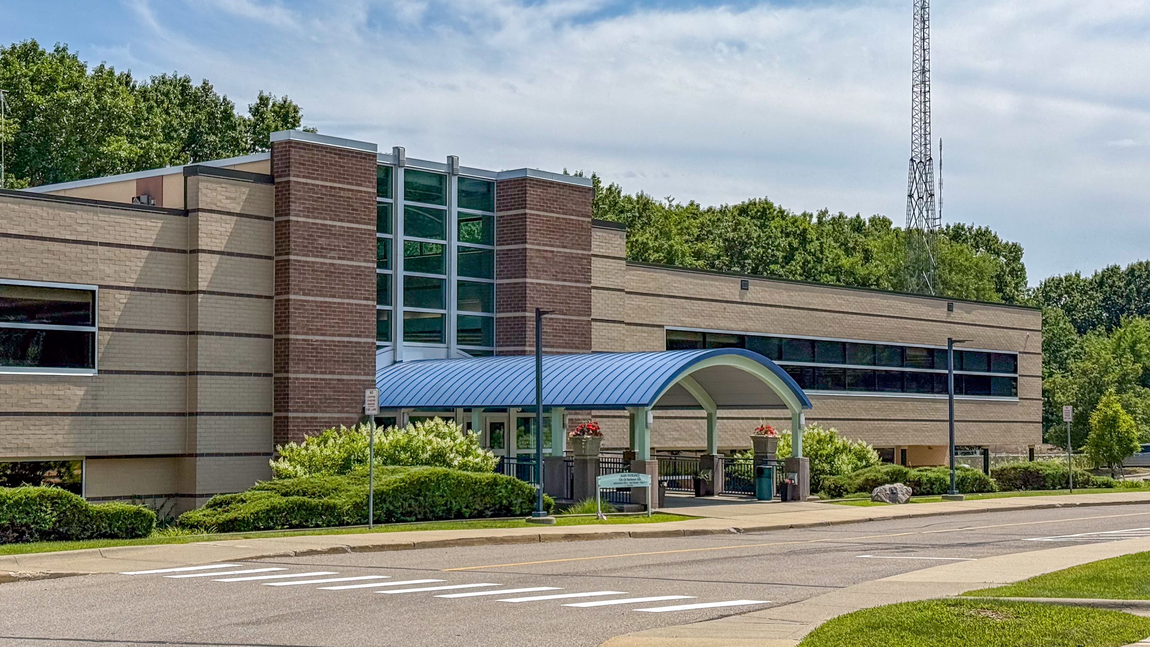 Two-story brick building with blue canopy entrance in Rochester Hills, Michigan.