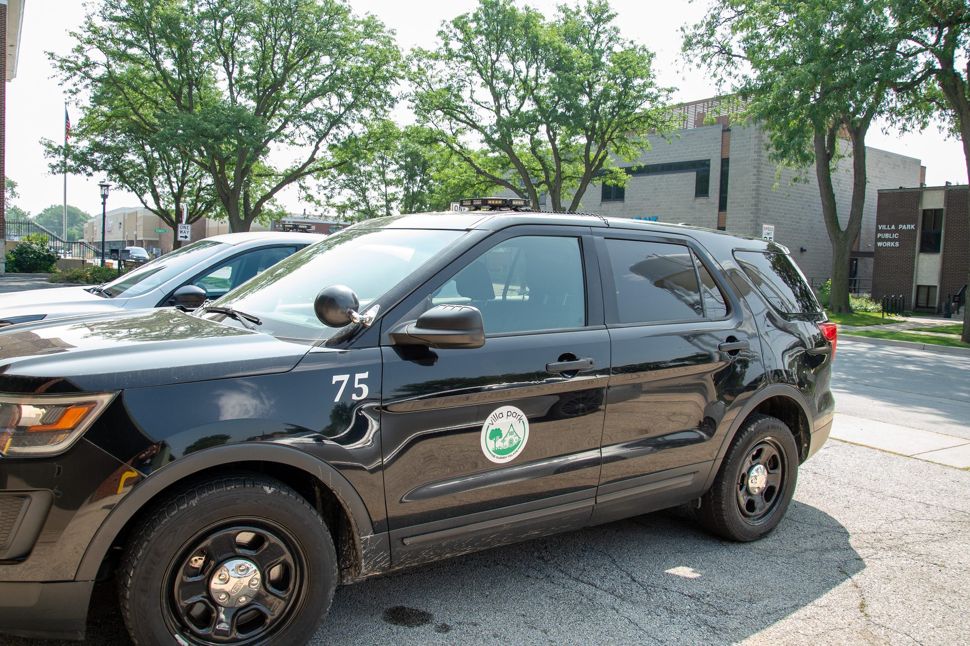Marked police department SUV parked outdoors.