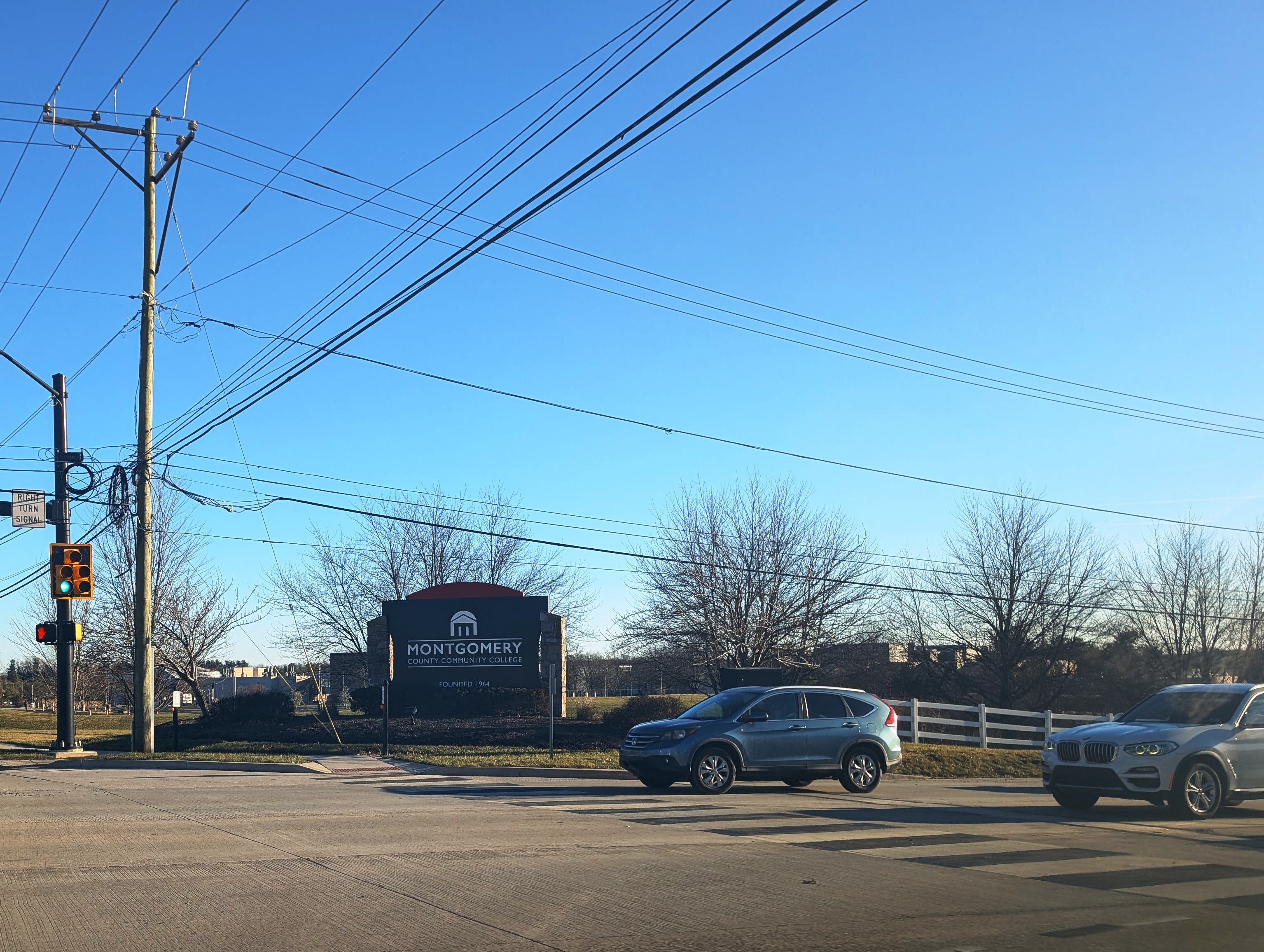 Entrance sign for Montgomery County Community College at a road intersection.