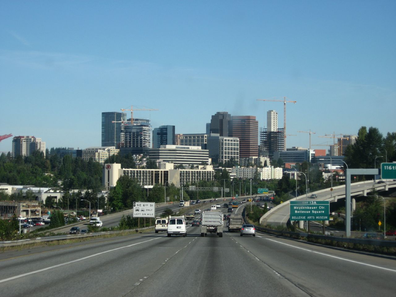 Multi-lane highway with vehicles heading toward the Bellevue downtown skyline.