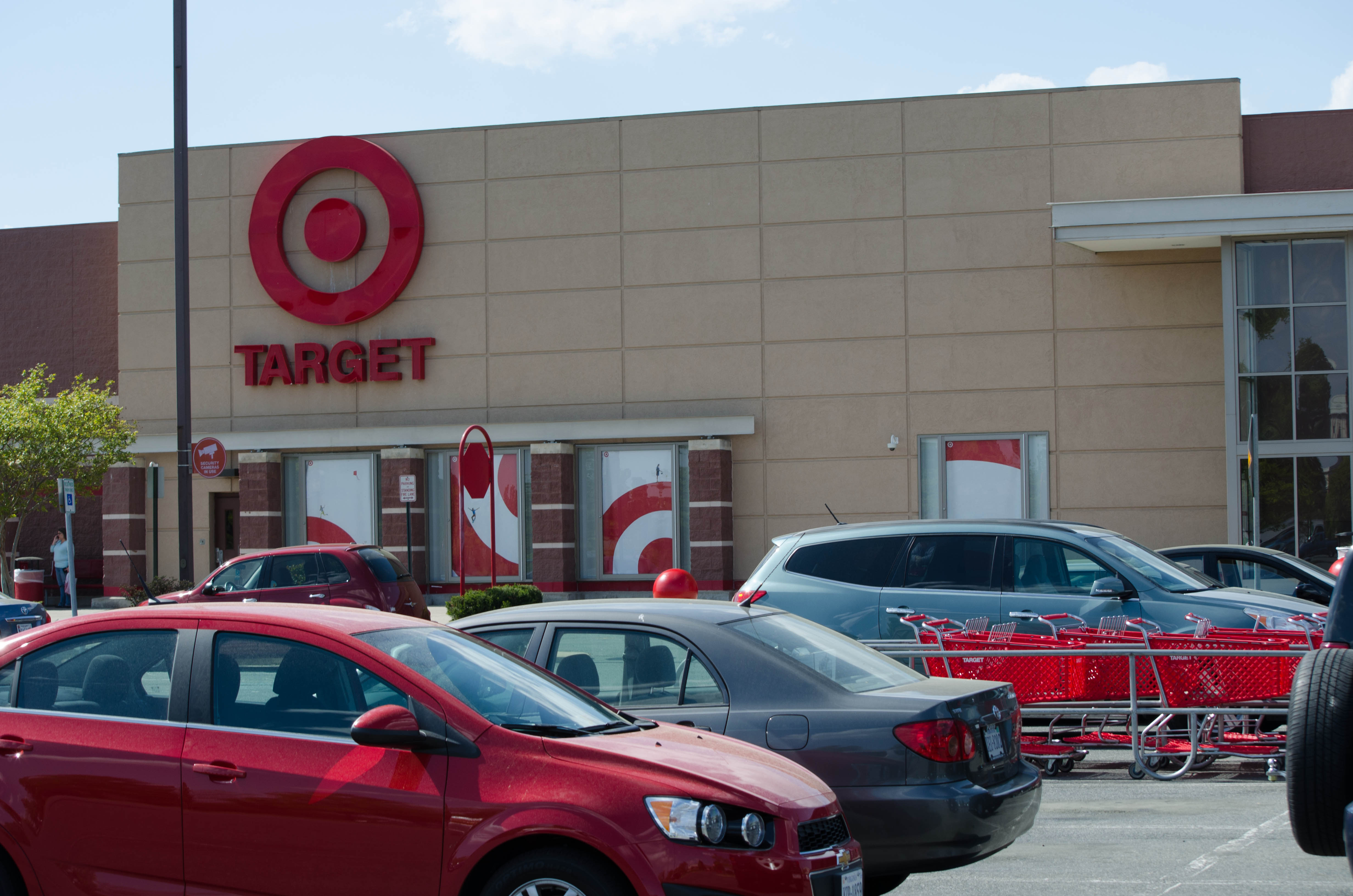 Exterior of a Target retail store with red bullseye sign and shopping carts in the parking lot.
