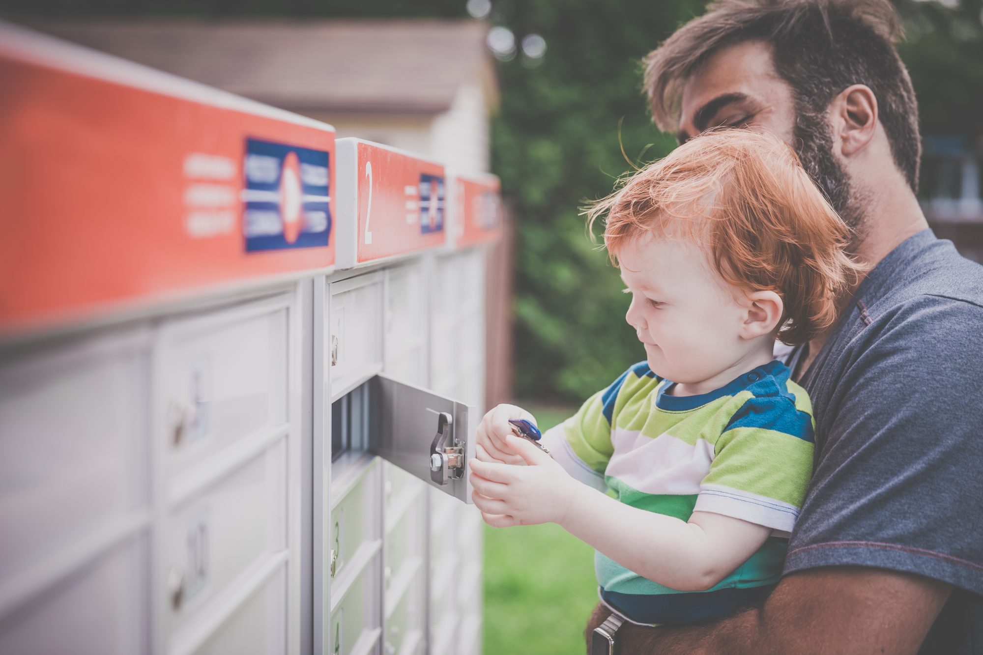 Baby Boy Opening a Mailbox with Parent