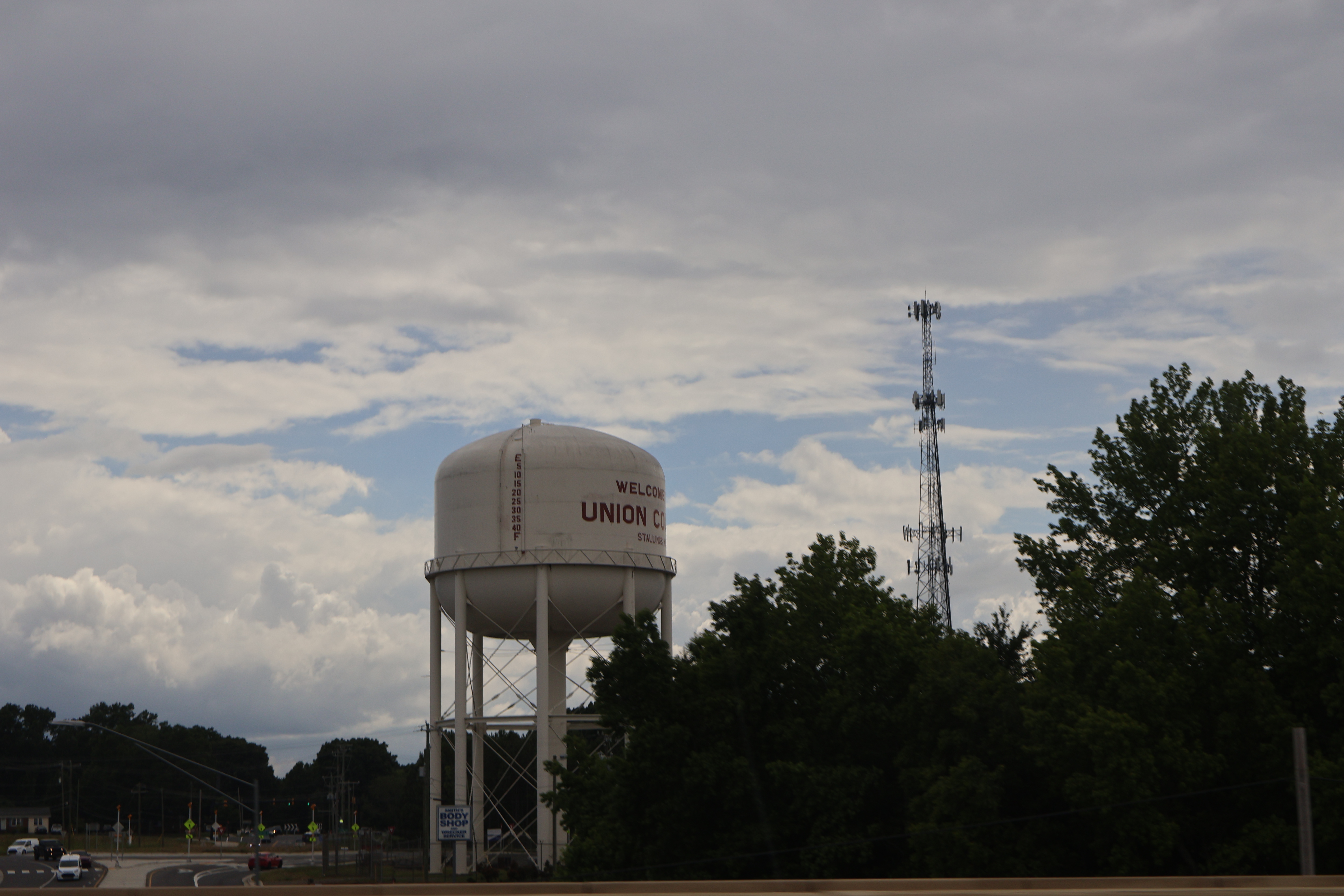 White water tower labeled Union County on a metal frame against a partly cloudy sky.