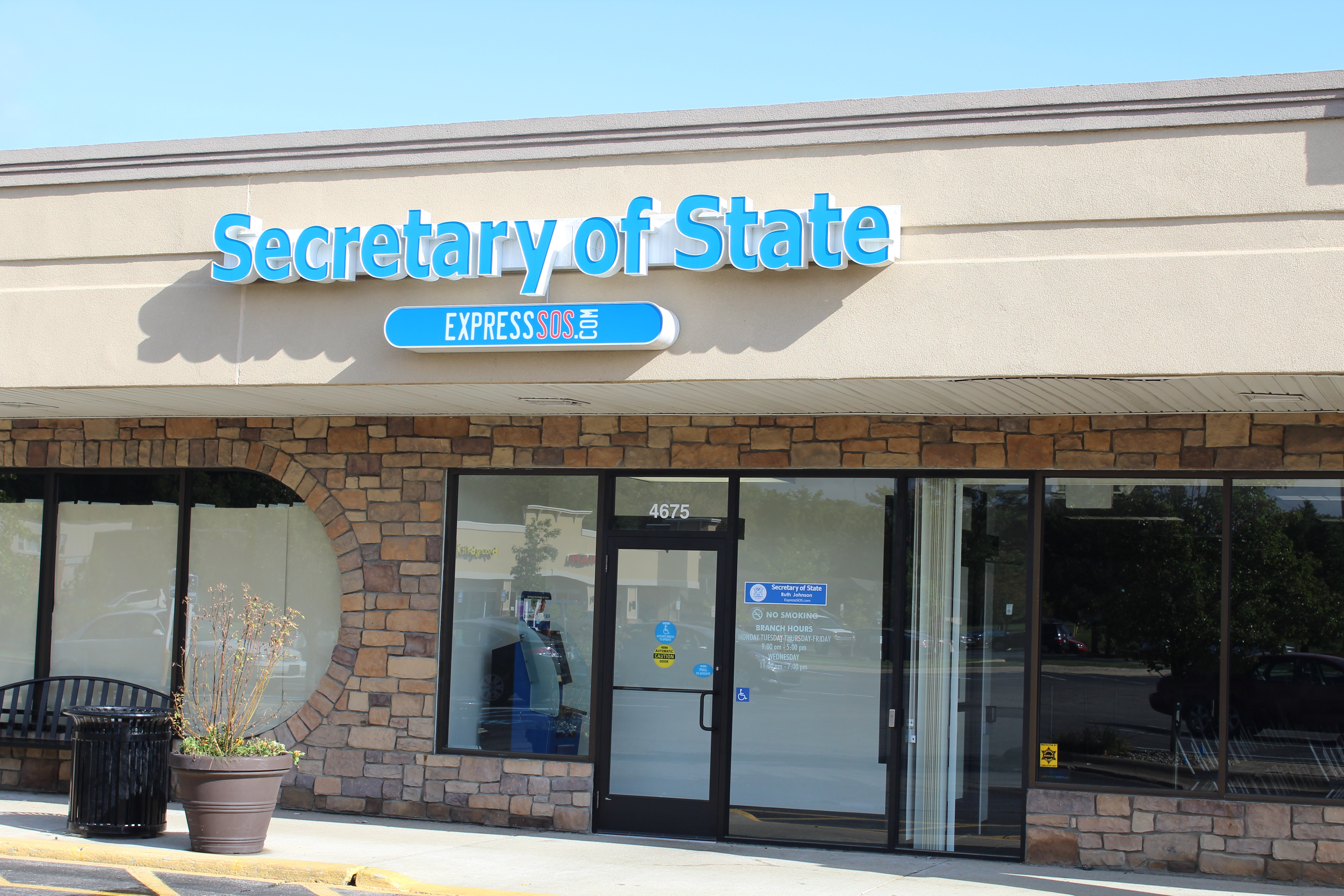 Storefront of a Michigan Secretary of State office with blue signage on a strip mall facade.