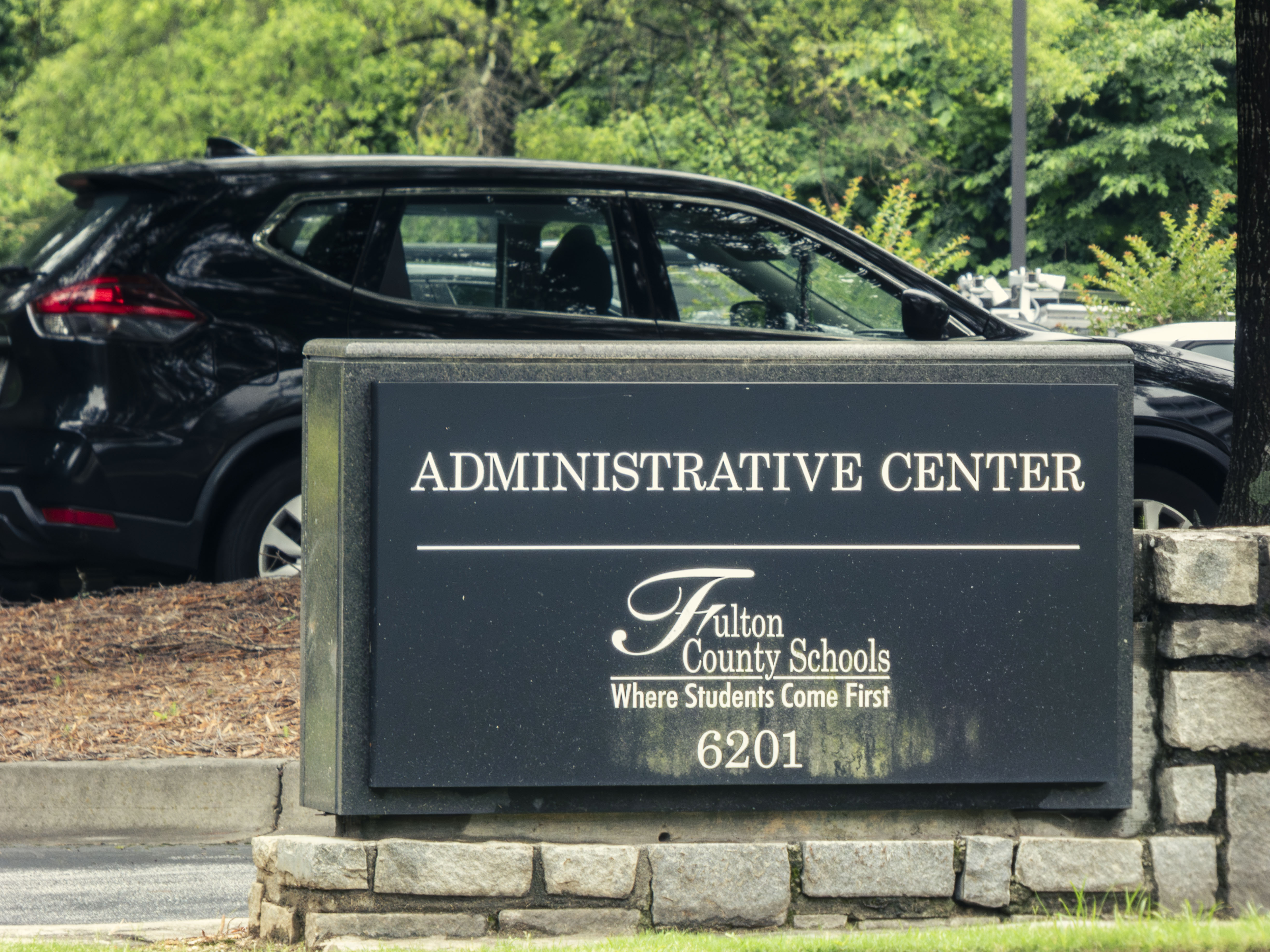 Stone sign reading Fulton County Schools Administrative Center mounted on a stone base.