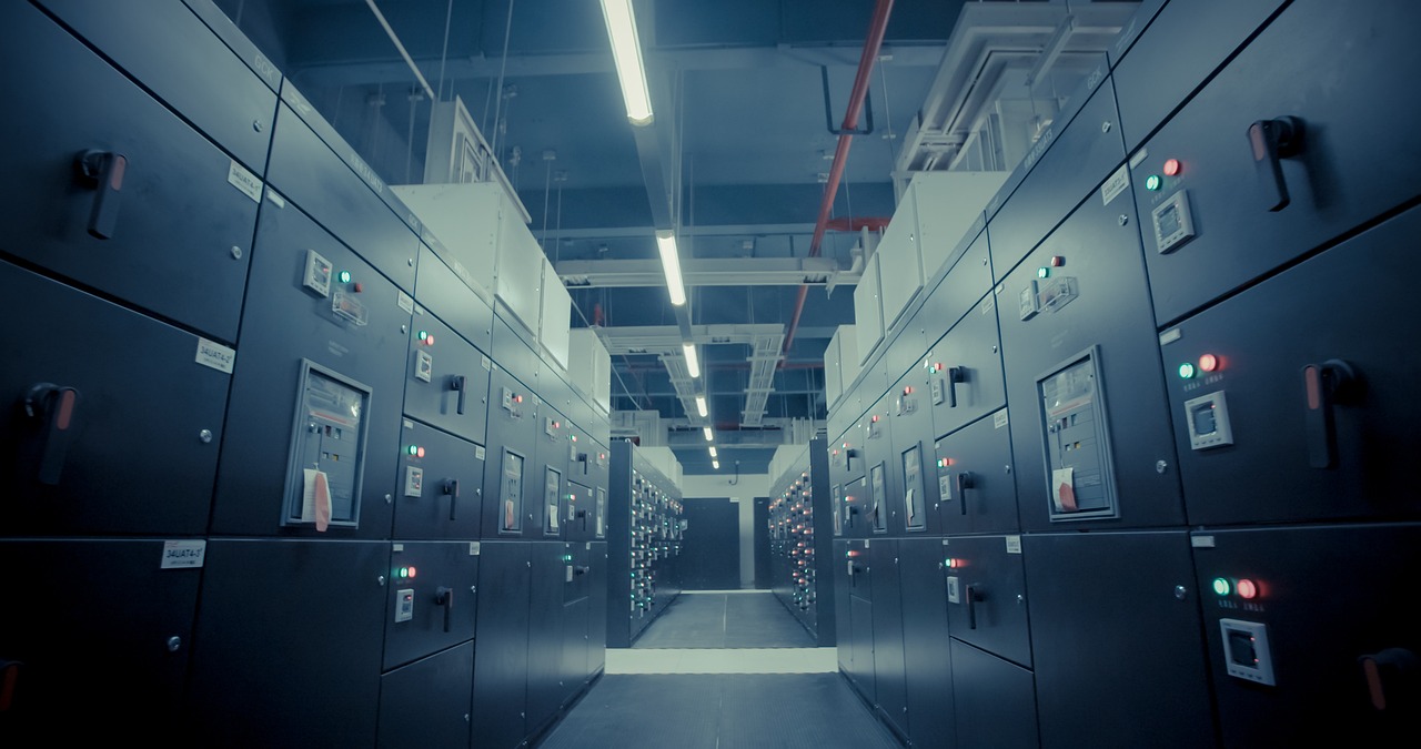 Rows of illuminated server racks inside a data center.