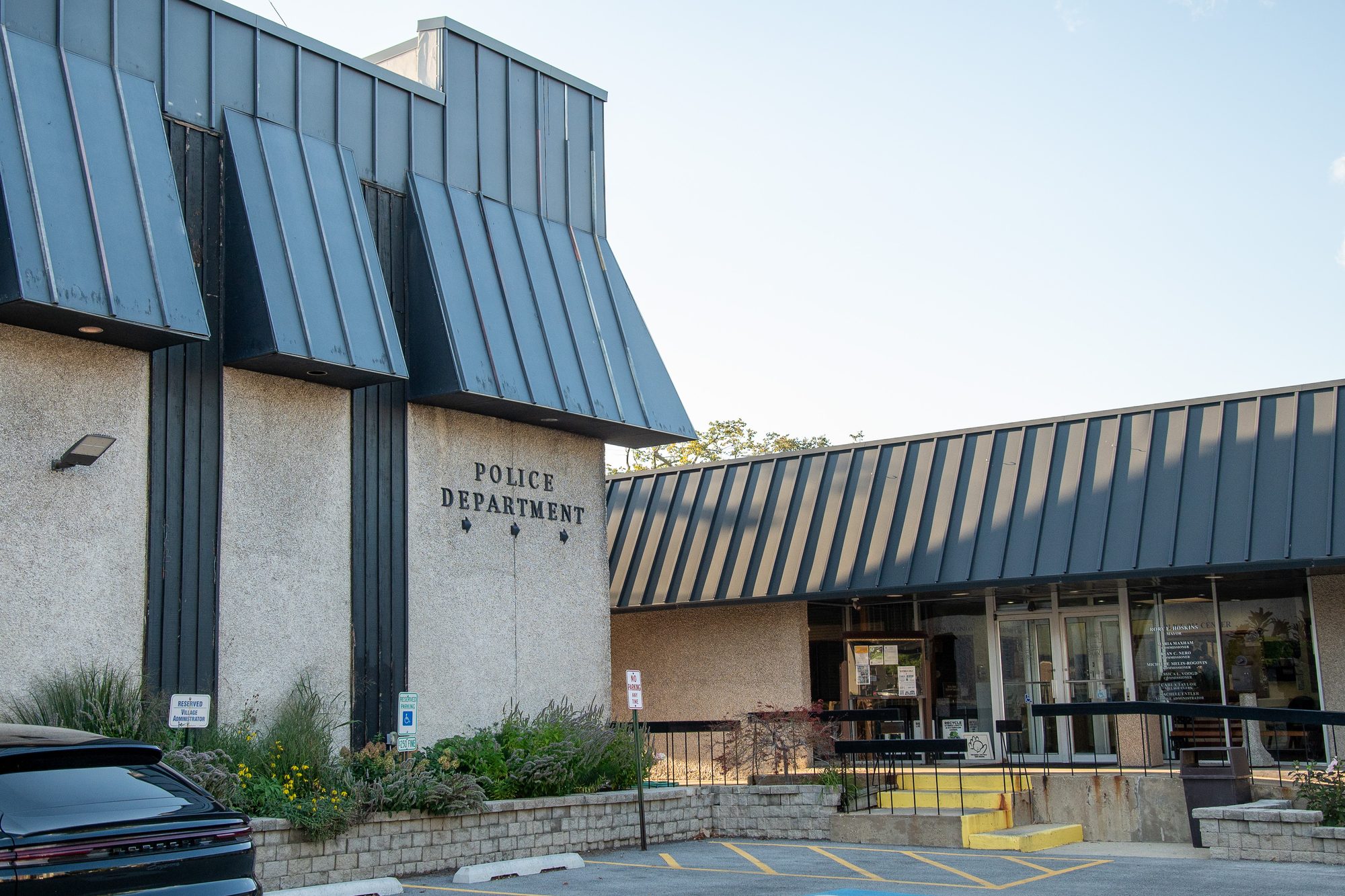 Exterior of a police department building with a dark metal angular roof.